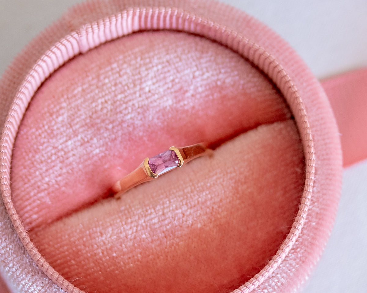 Pink sapphire ring in 14K rose gold in a pink jewelry box, close-up