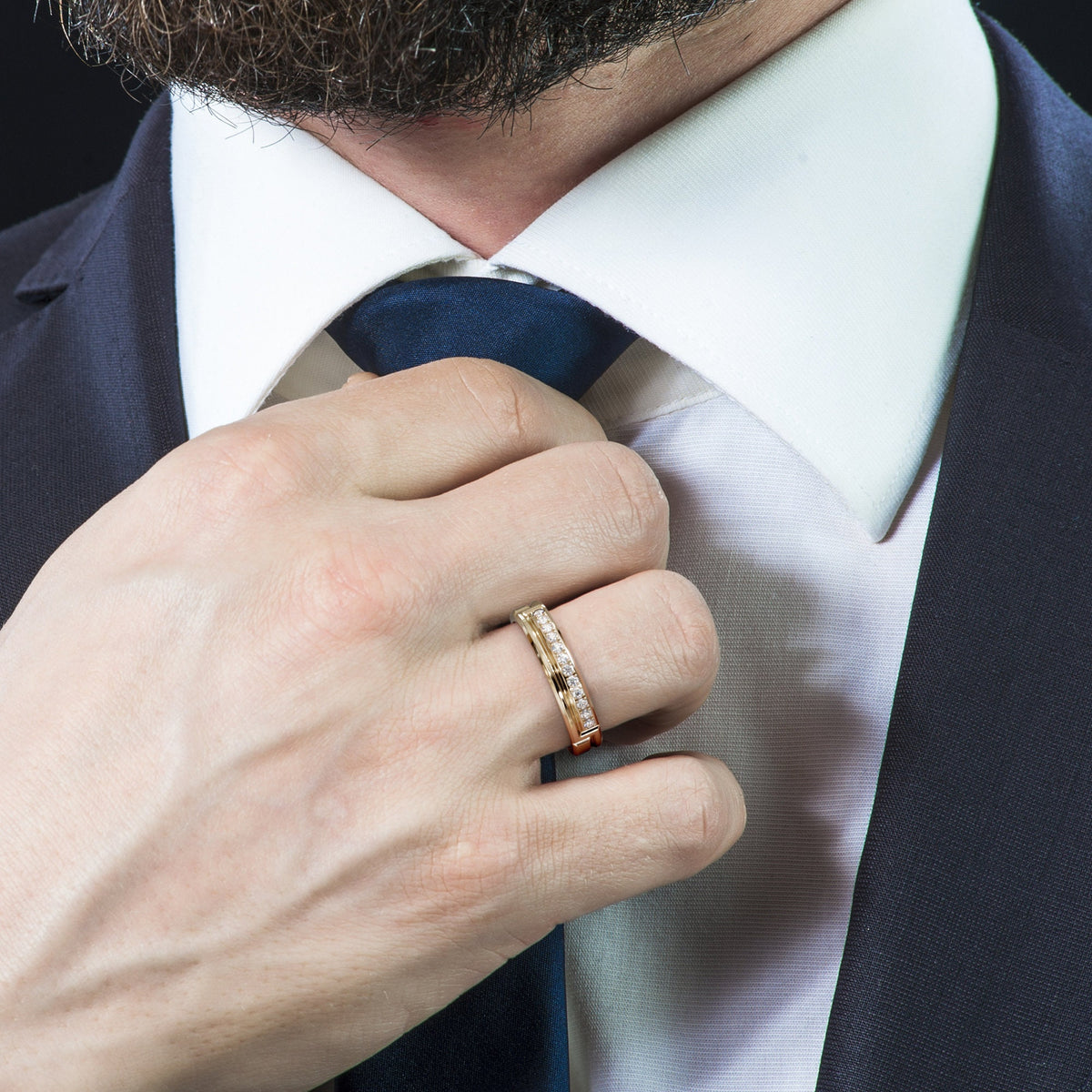 White gold diamond wedding band worn on a man's hand