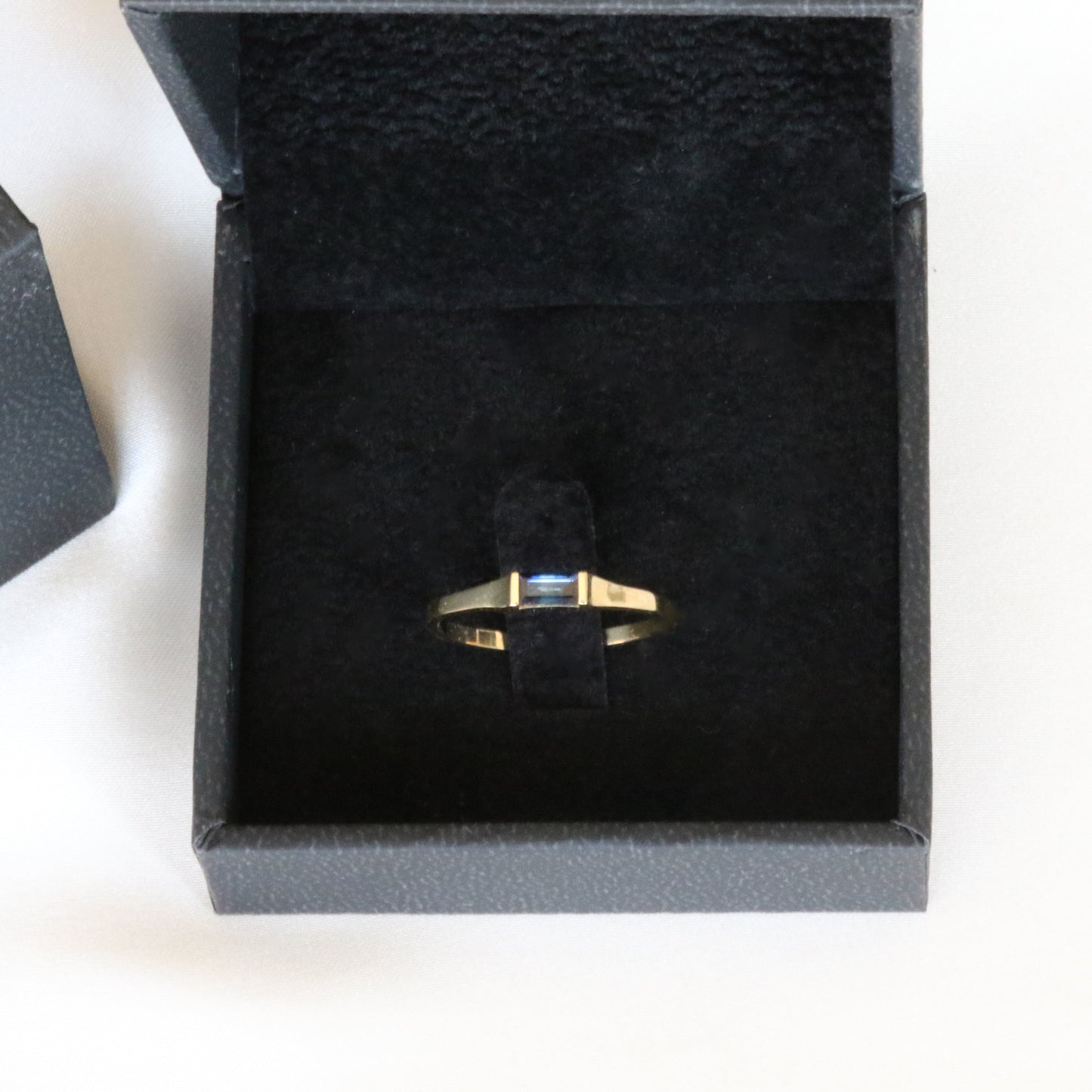 sapphire baguette ring in black velvet box