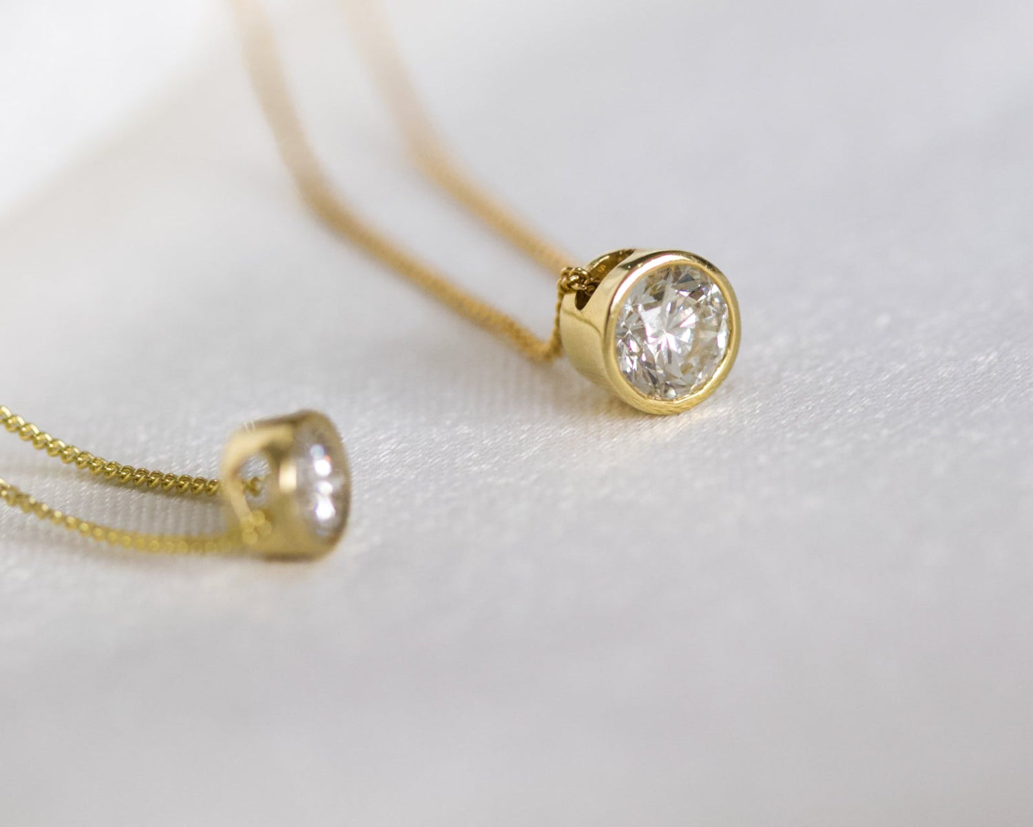 Layered 14K gold necklaces featuring heart and infinity pendants – elegant fine jewelry for women, handcrafted in solid gold with a timeless romantic design.