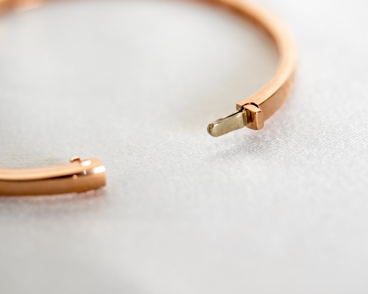 Close-up of 14K gold diamond bangle clasp mechanism