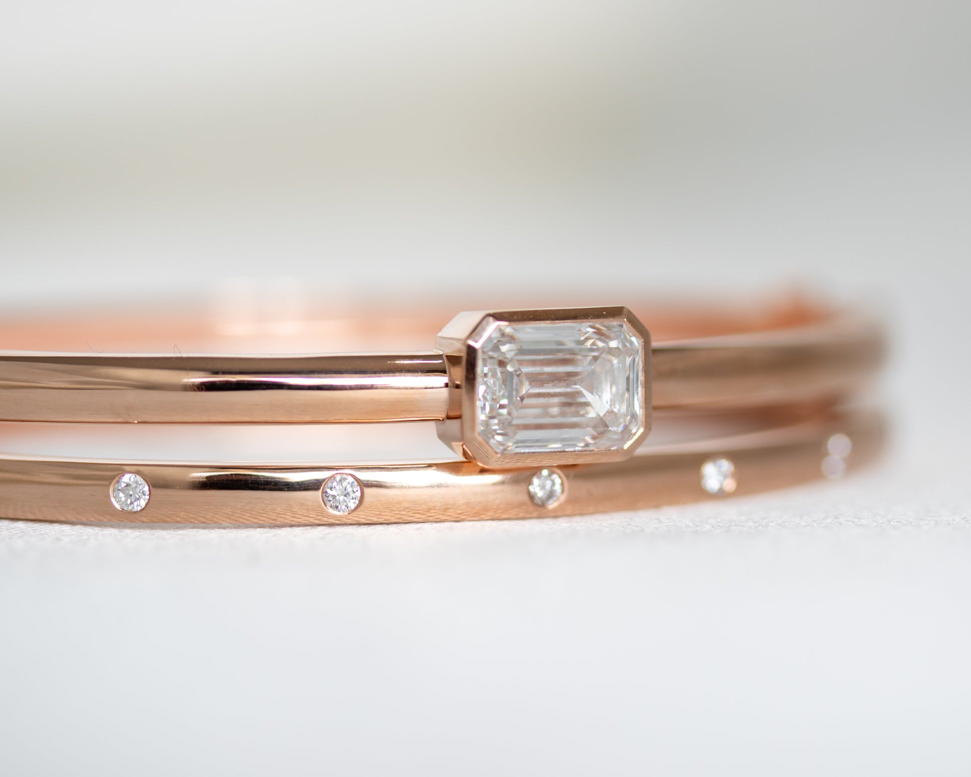 Two 14K gold diamond bangles stacked together