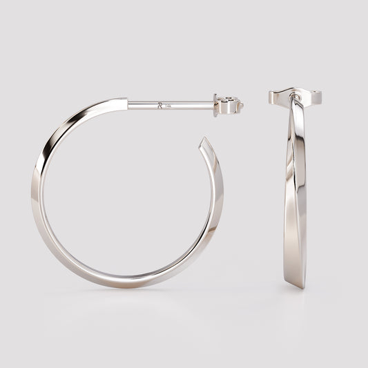 Side and front view of 14K white gold twist hoop earrings, modern geometric sculpted design from the Twist collection, minimalist fine jewelry on light gray background.