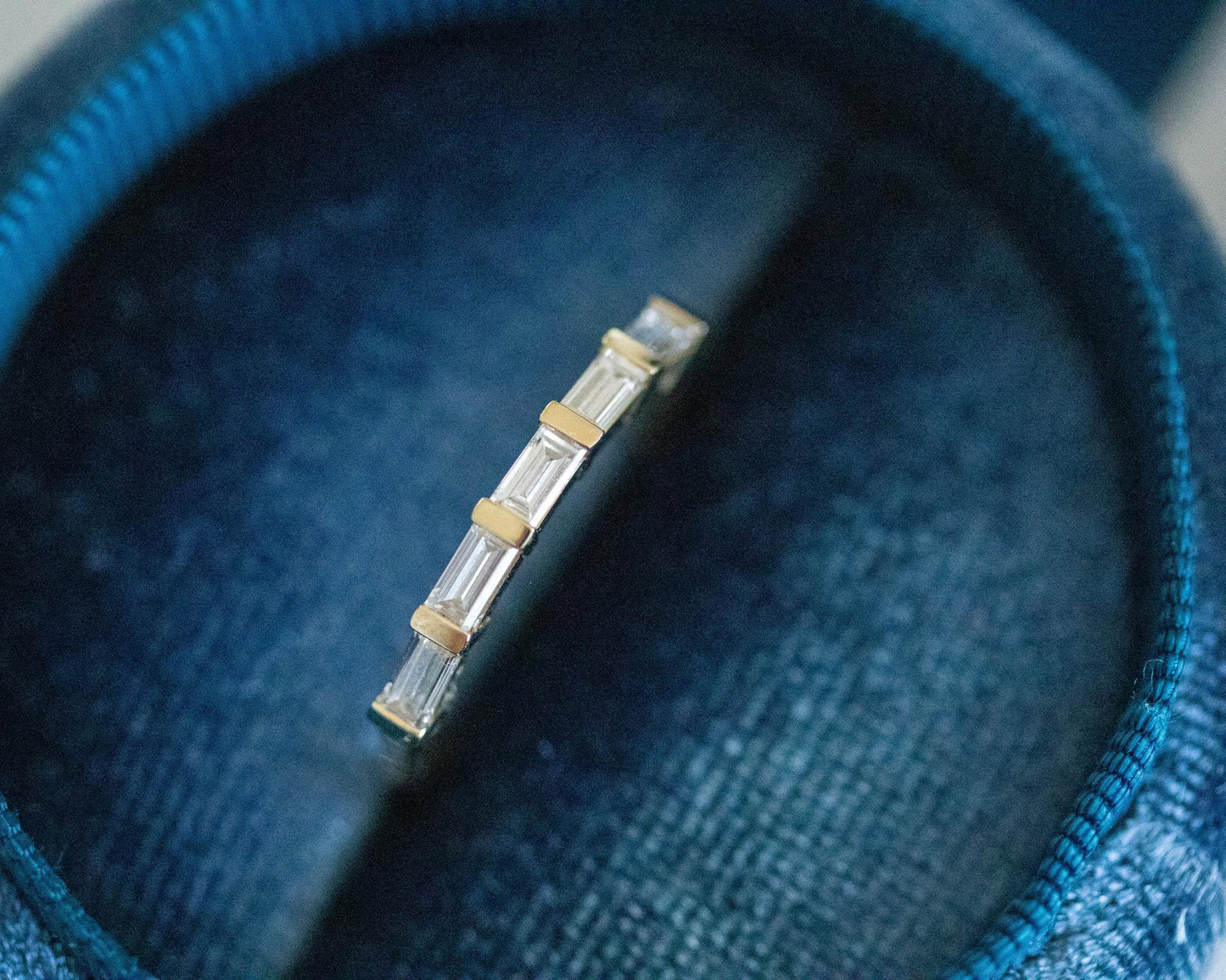 gold eternity ring with baguette cut diamonds