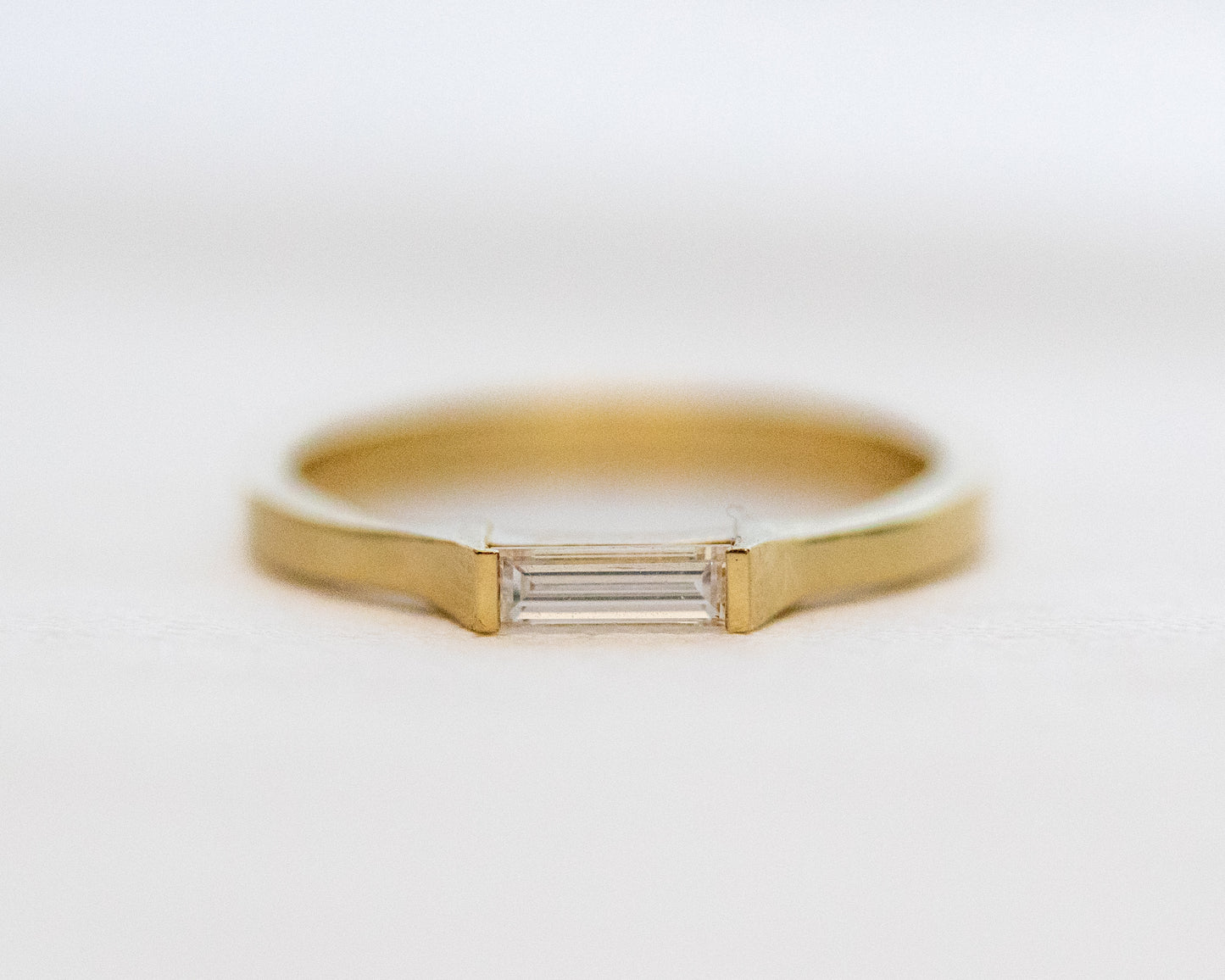 Baguette diamond half-bezel ring in 14K gold