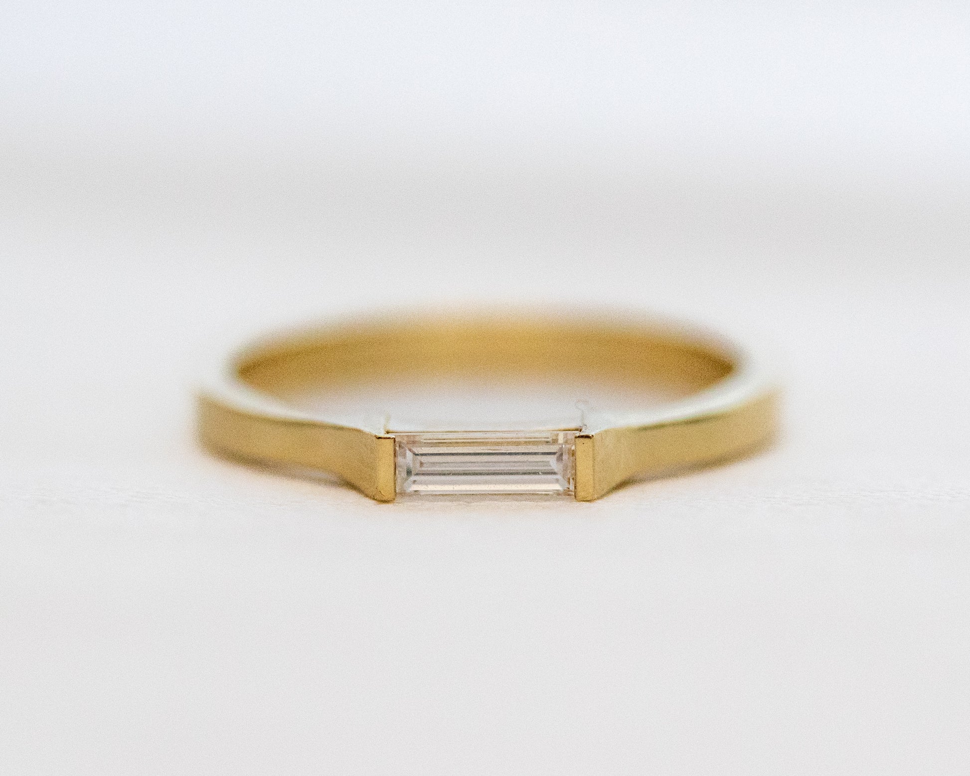 Baguette diamond half-bezel ring in 14K gold