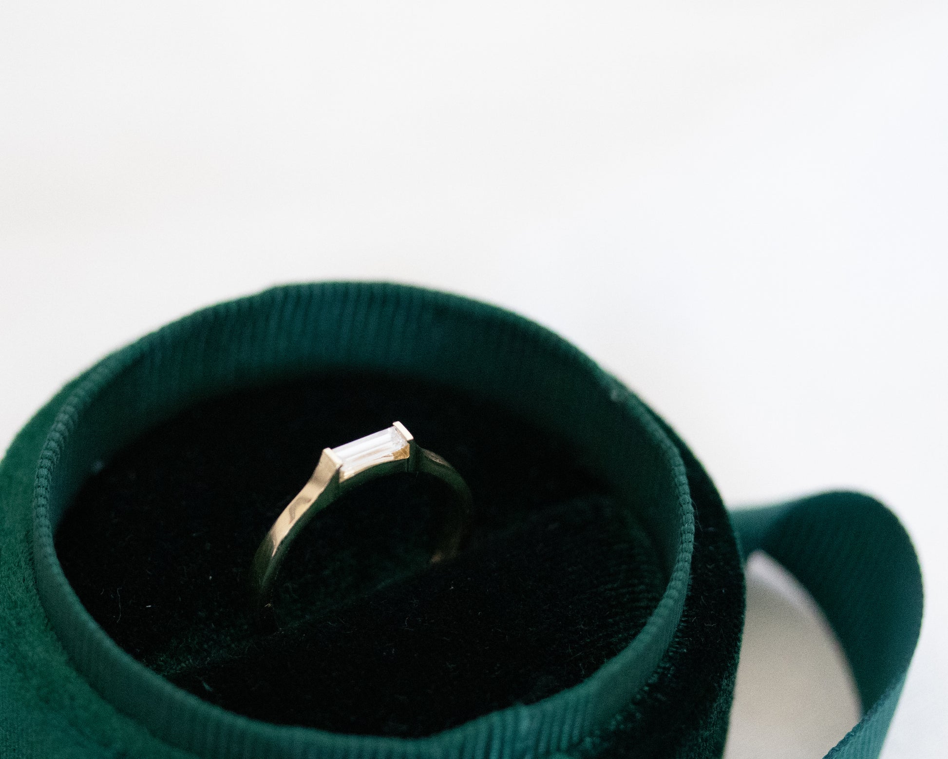 14K gold baguette diamond ring in a velvet box