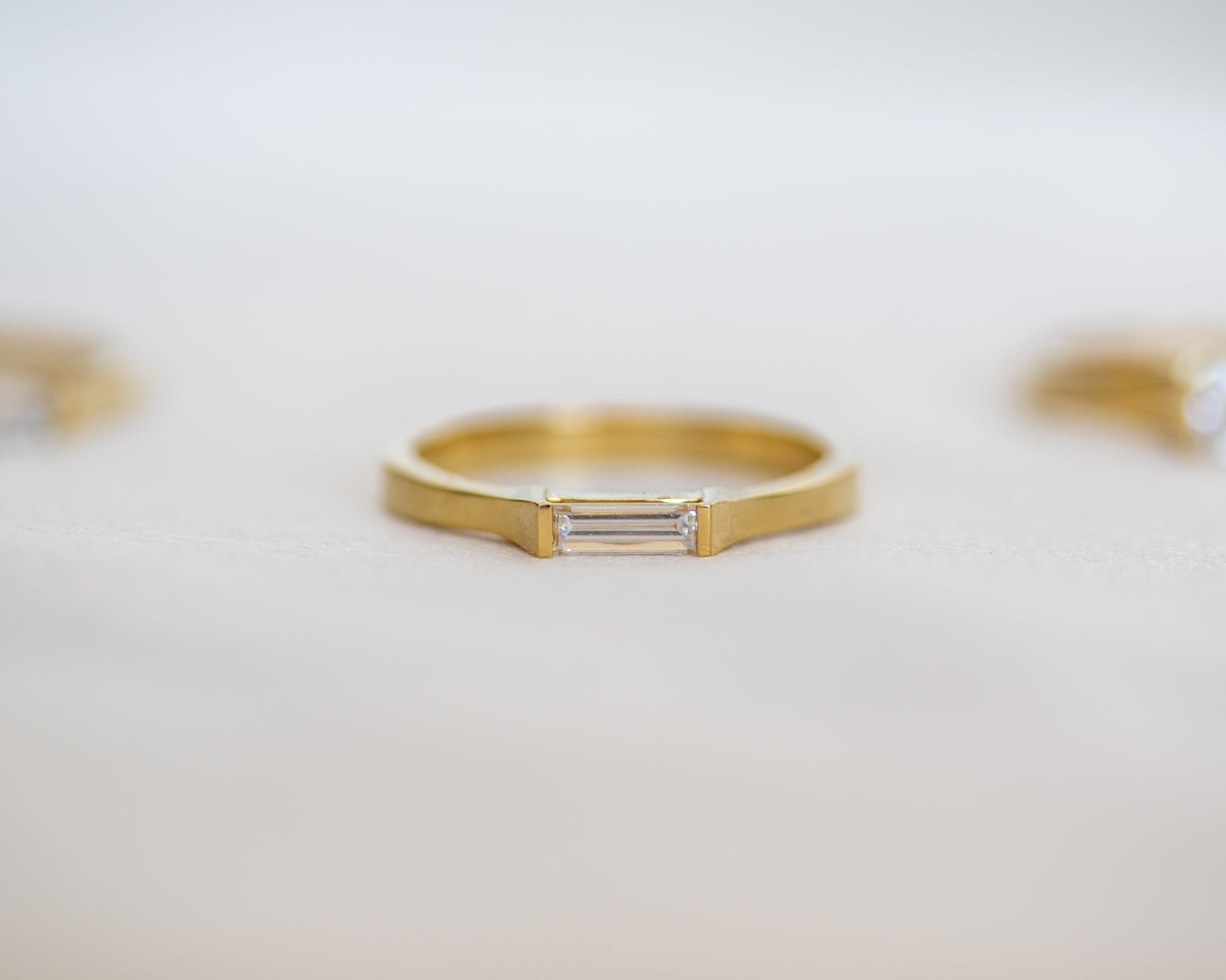 Slim 14K gold band with east-west baguette diamond