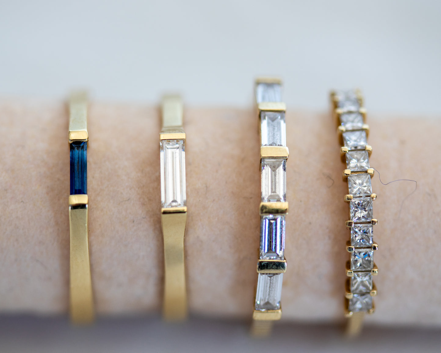 Baguette diamond ring stacked with gold bands