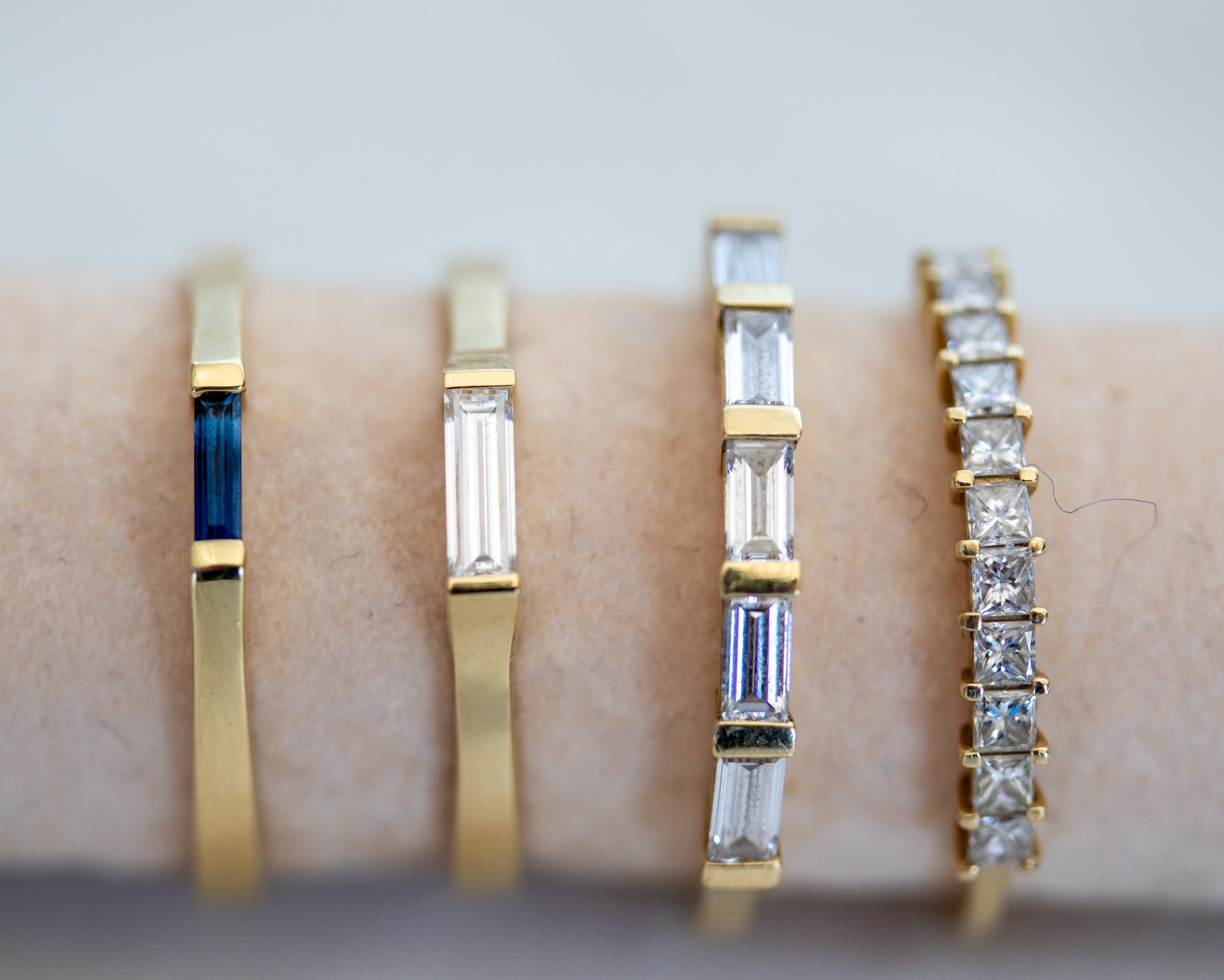 Baguette diamond ring stacked with gold bands
