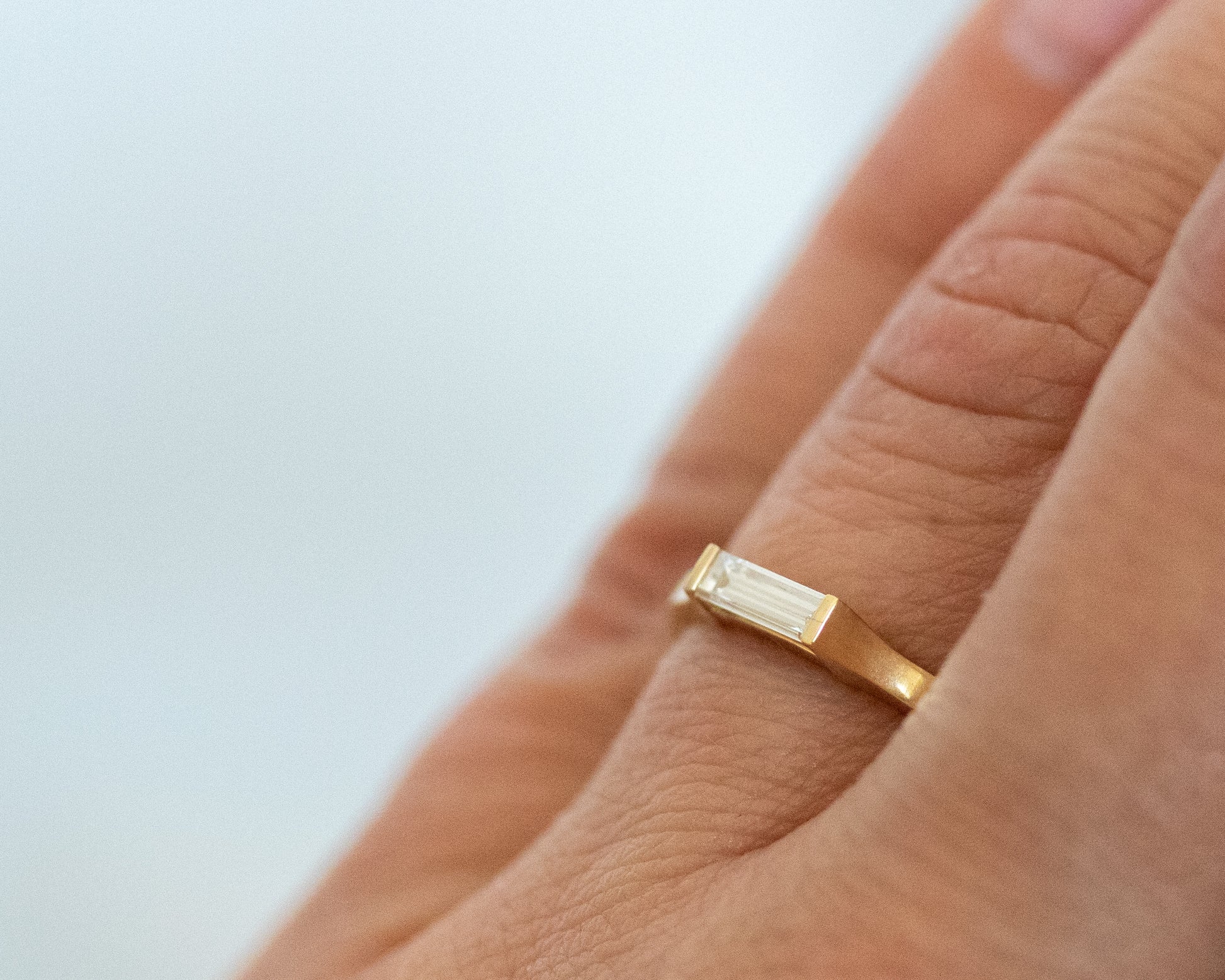 East-west baguette diamond ring worn on the hand