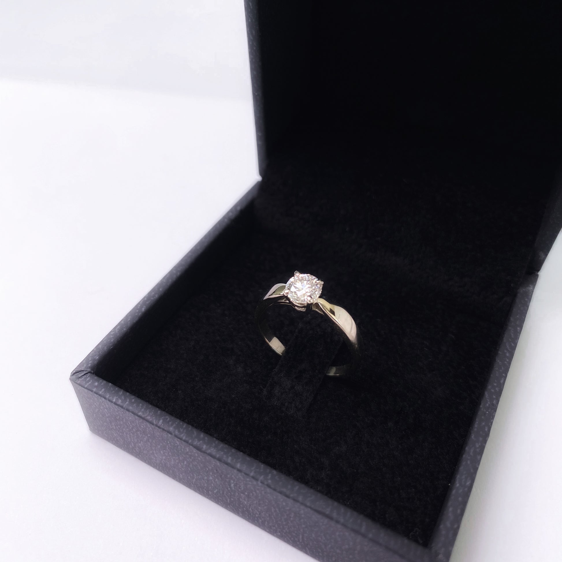 chunky white gold solitaire ring in black box