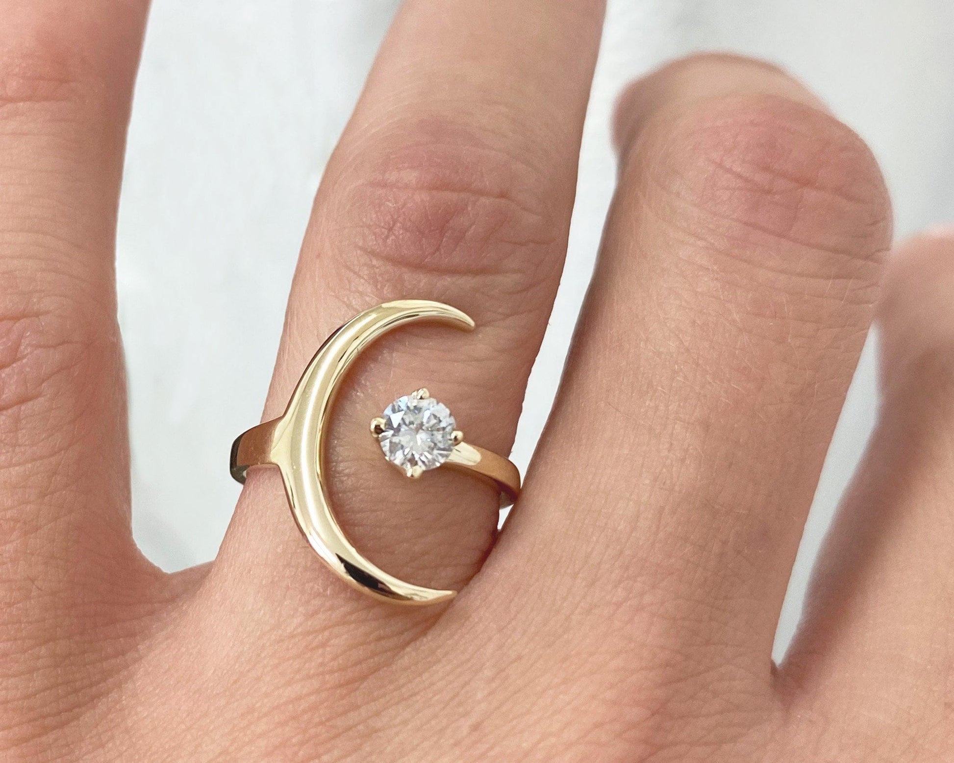 Solid gold crescent moon ring with a natural round diamond
