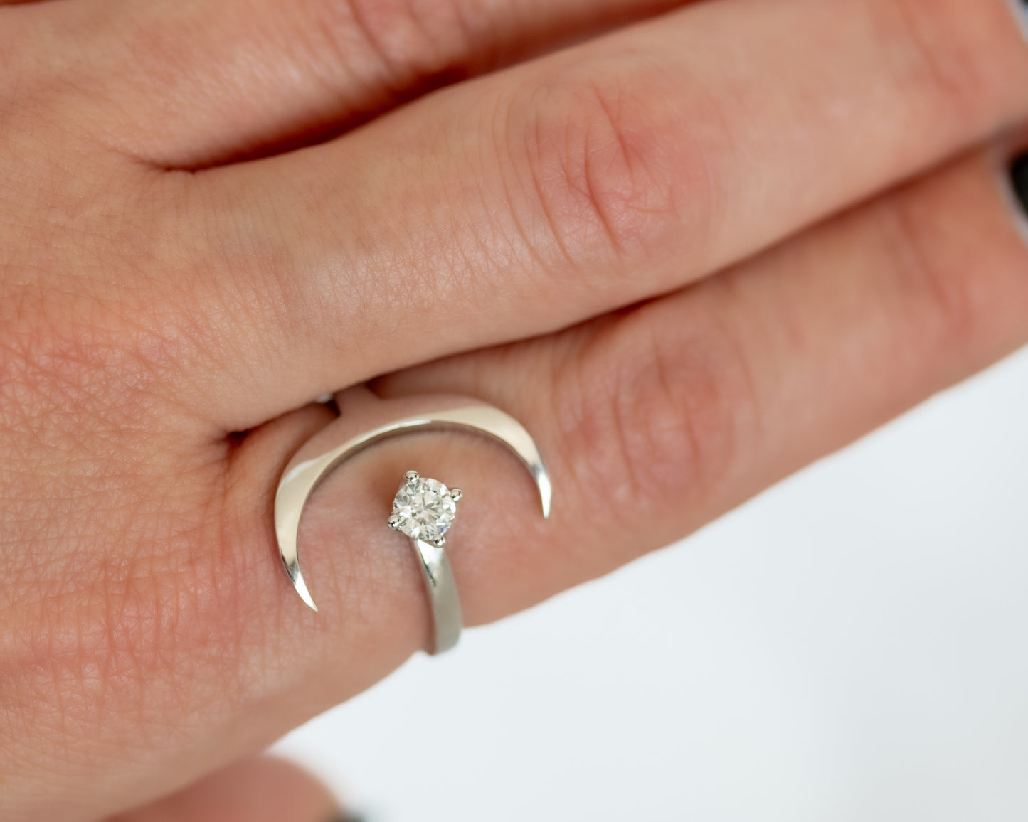 Crescent moon solitaire ring set with a round diamond