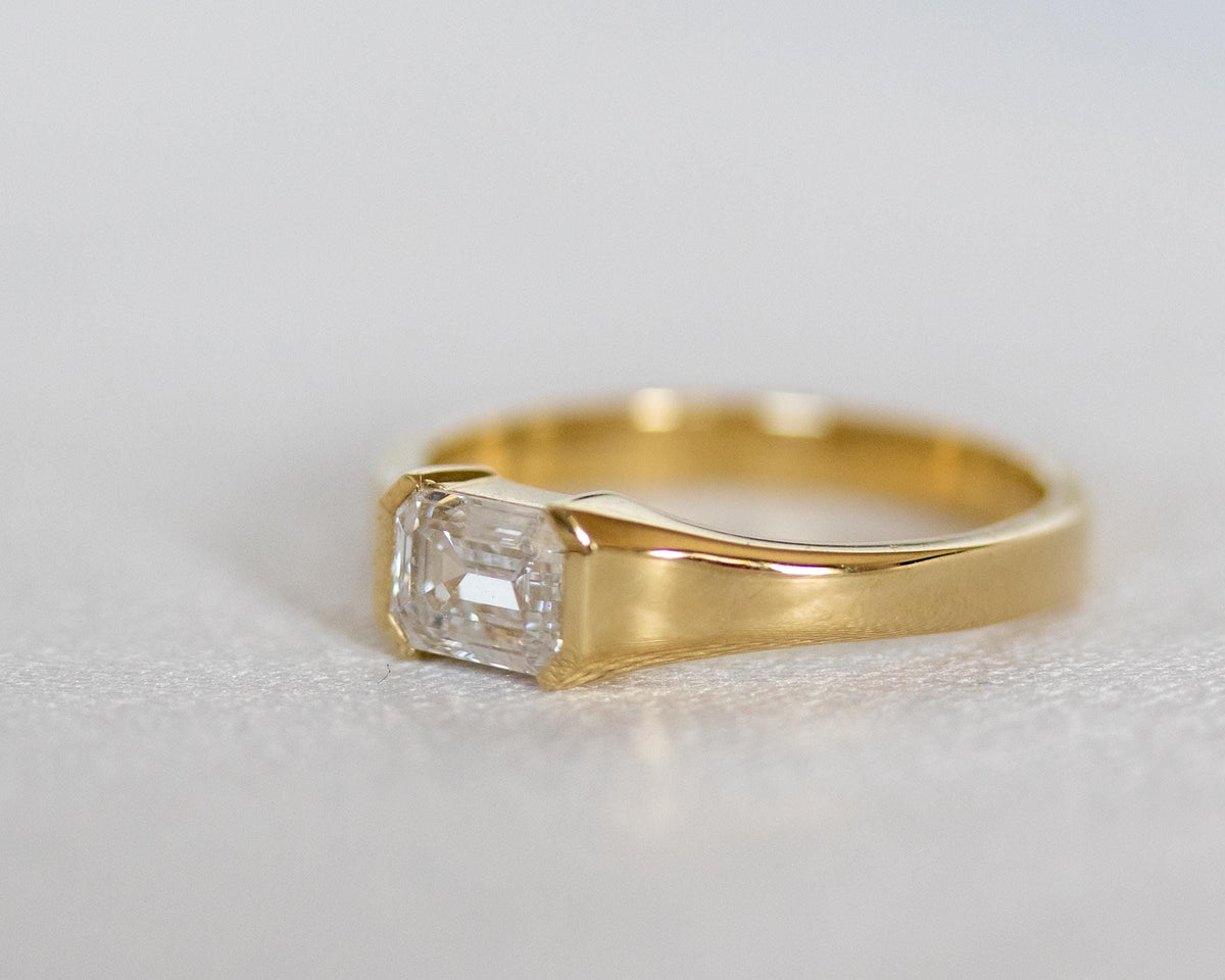 Emerald cut diamond solitaire ring in 14K yellow gold, side view