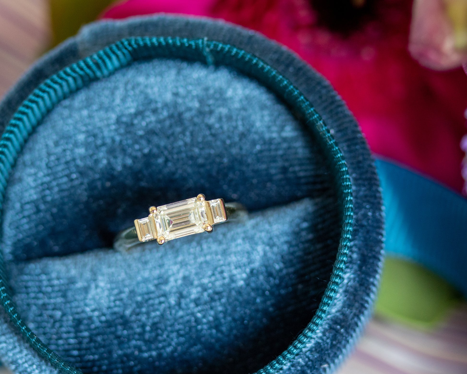 Emerald cut diamond trilogy ring in teal velvet ring box