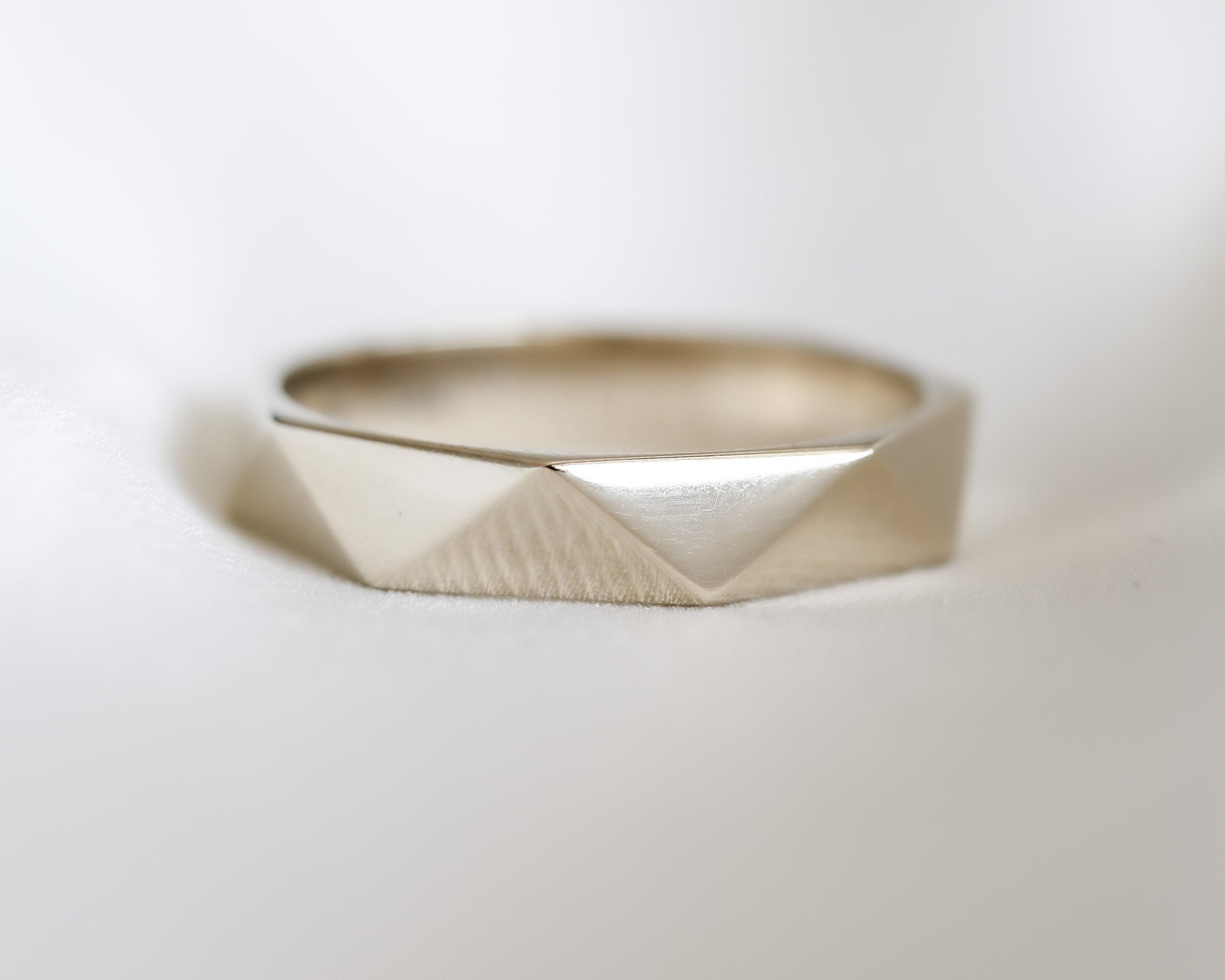 faceted triangle band gold ring side view soft light