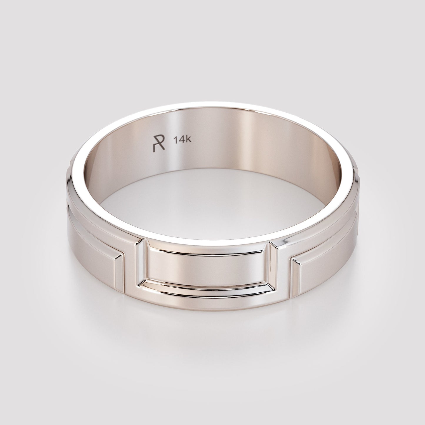 fingers holding carved gold ring edge view
