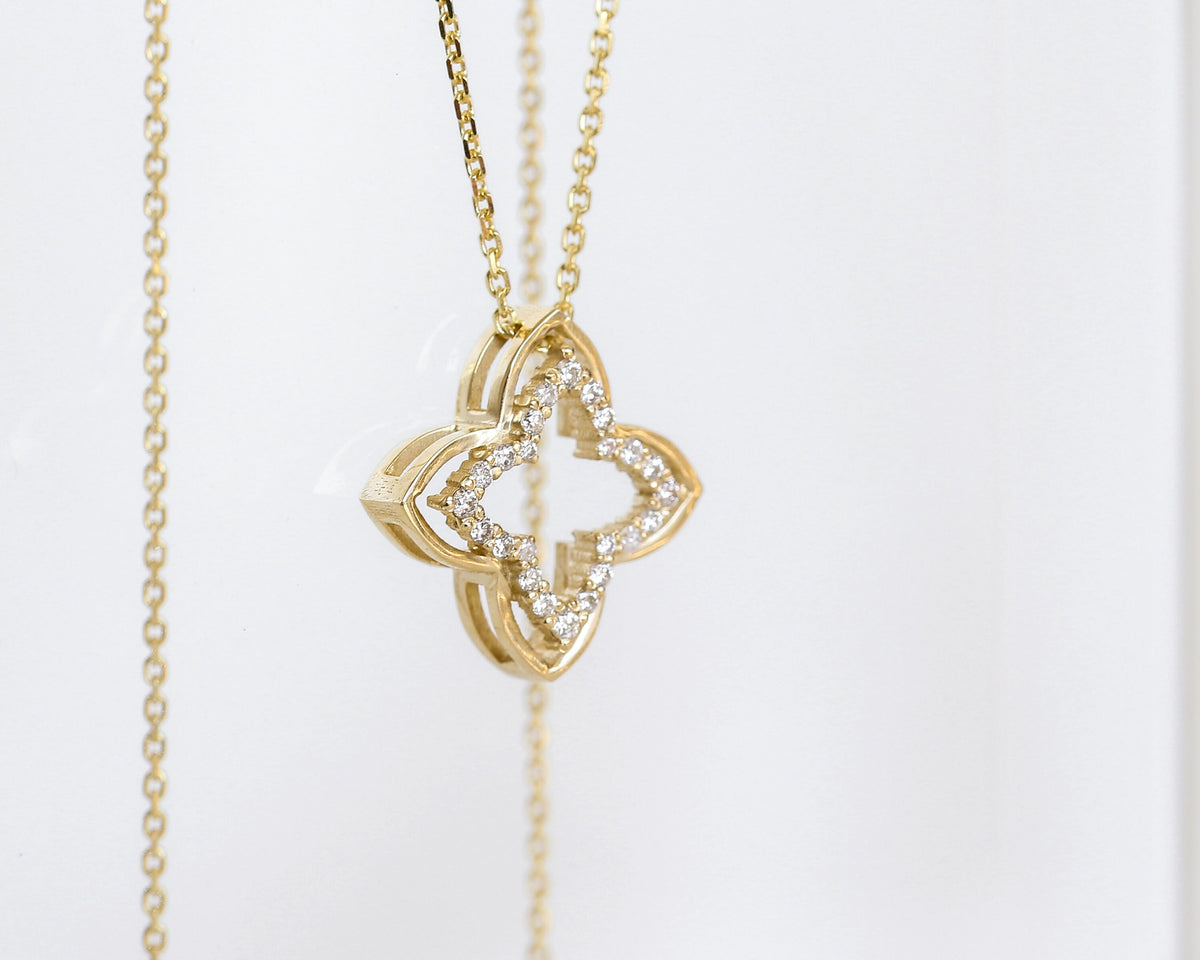 14K yellow gold four-leaf clover diamond pendant on a rolo chain, hanging, side view