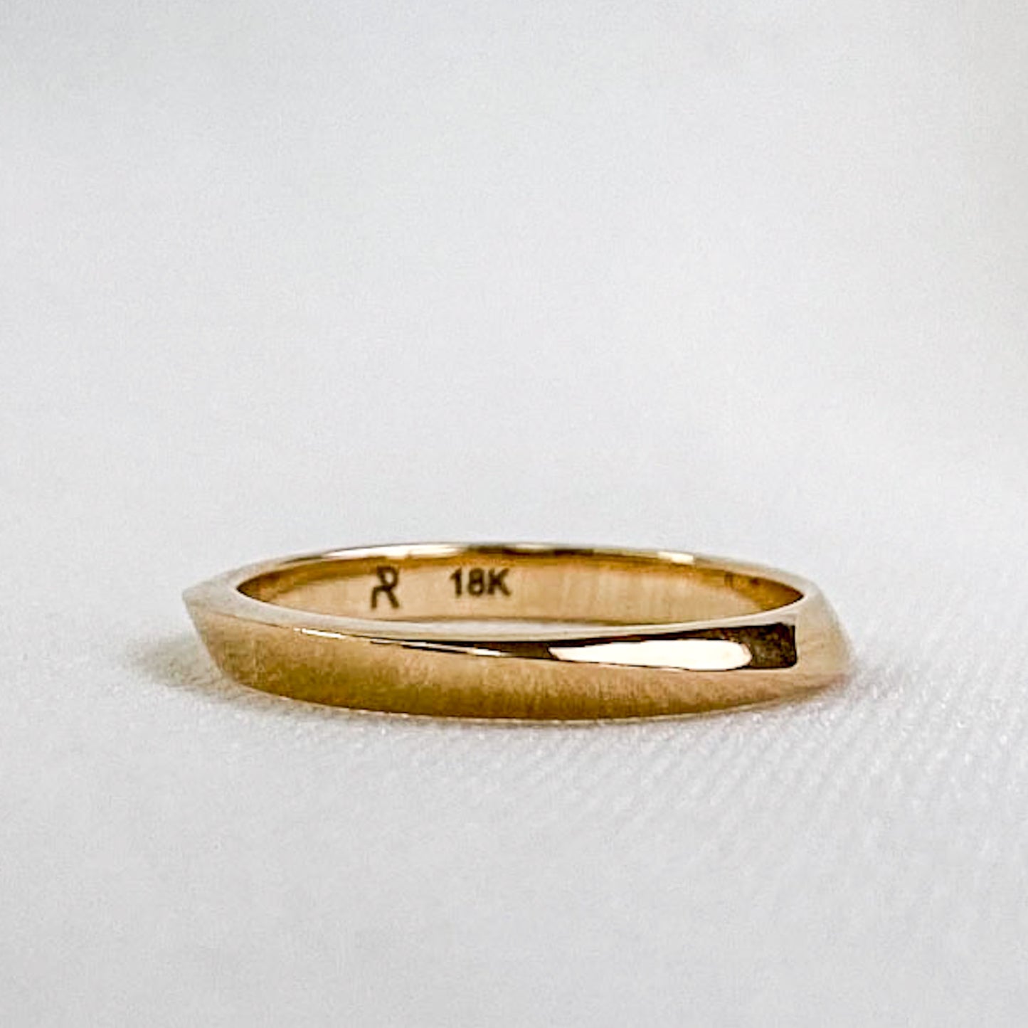 geometric gold wedding ring on white background
