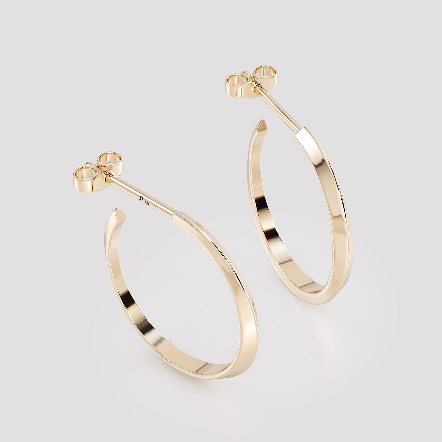 Pair of 14K gold geometric hoop earrings from the Twist collection, handcrafted modern fine jewelry with sleek sculptural curves and polished finish.