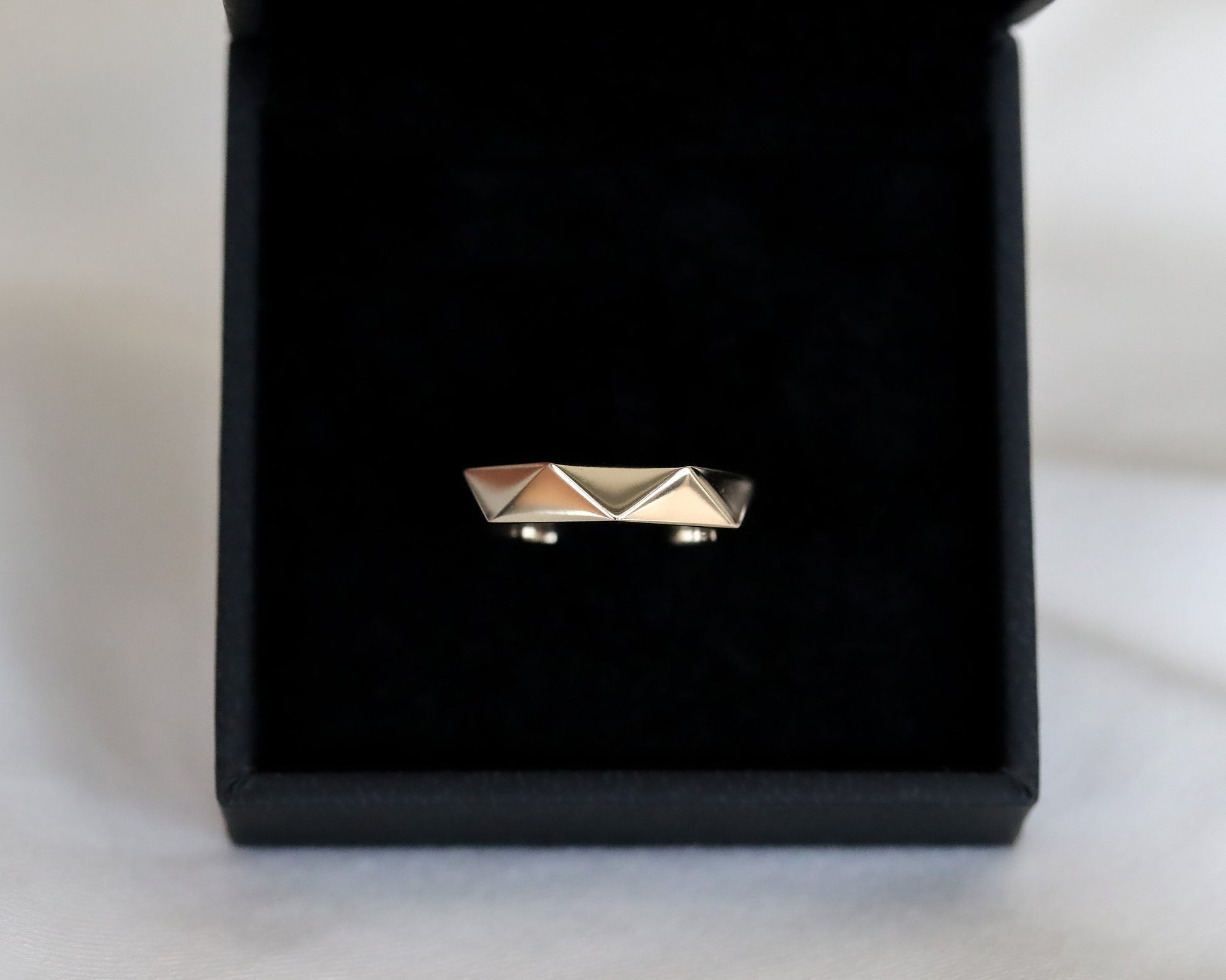 gold ring inside black velvet jewelry box