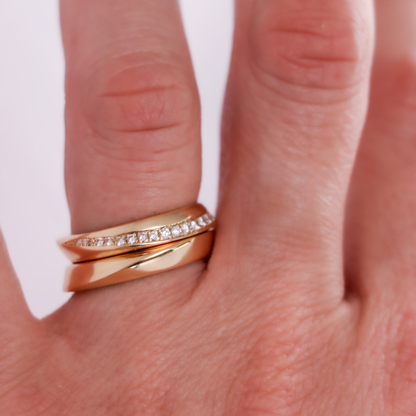 two gold rings set on hand