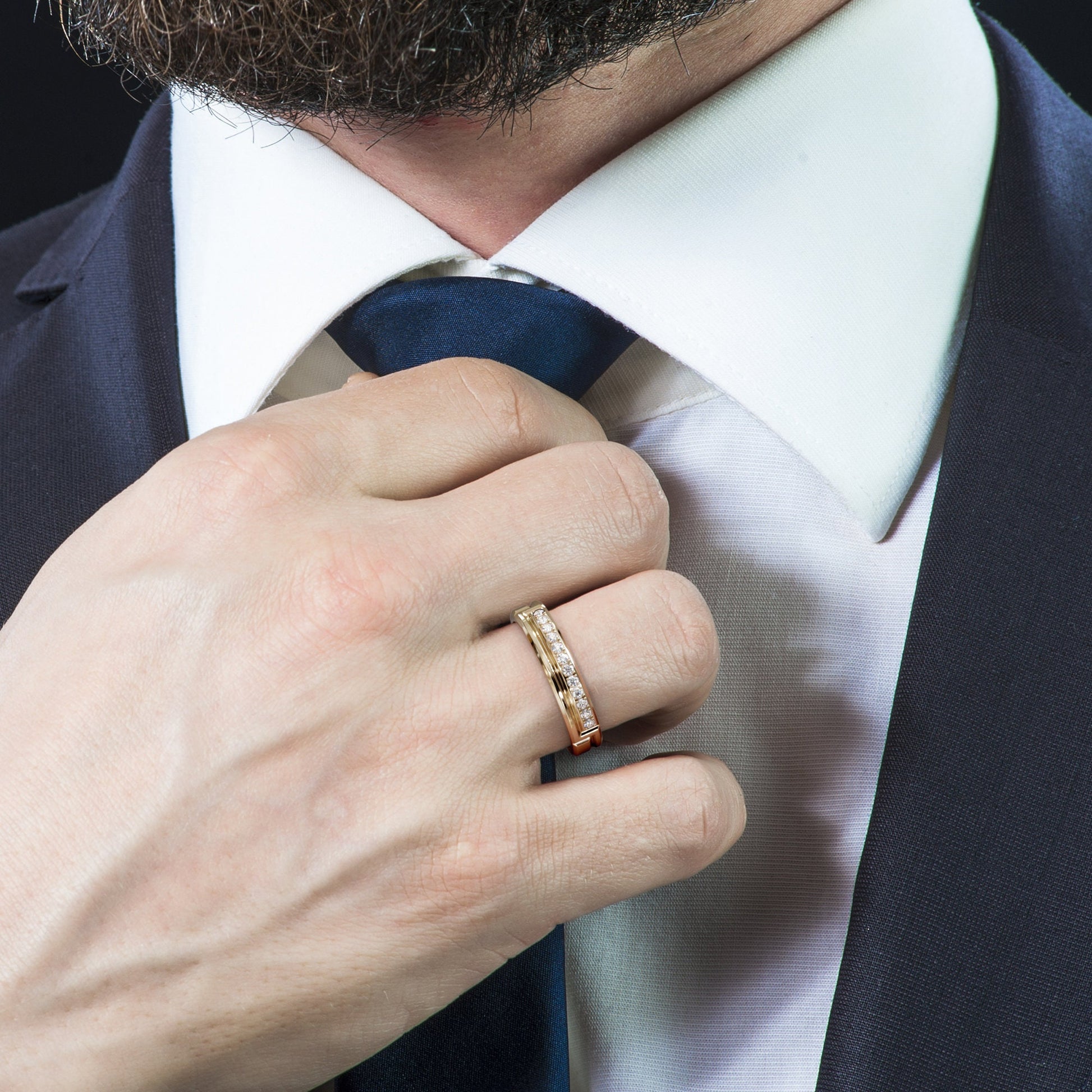 hand adjusting tie wearing diamond gold ring