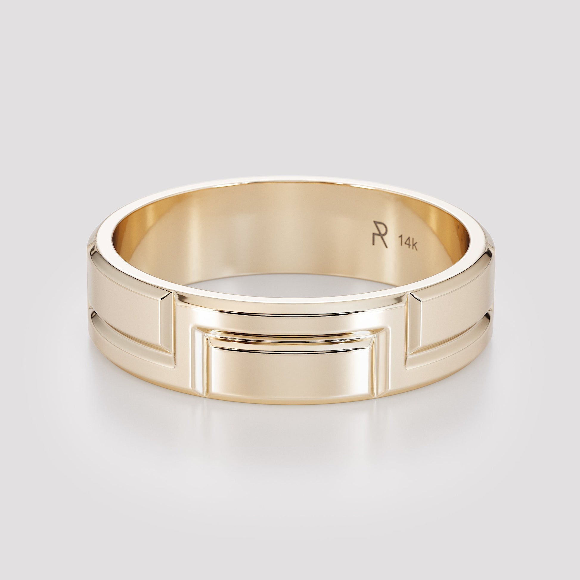 hand wearing carved gold band close up