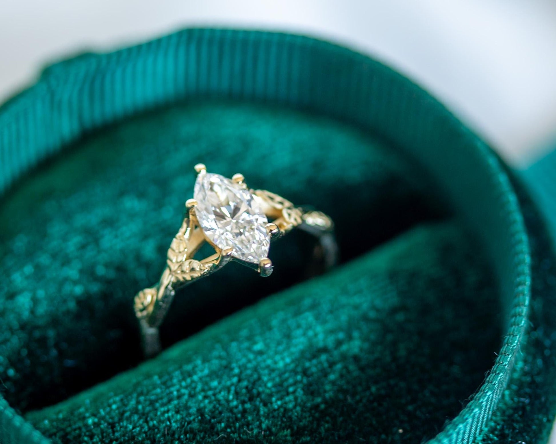 Gold ring with a diamond on green velvet