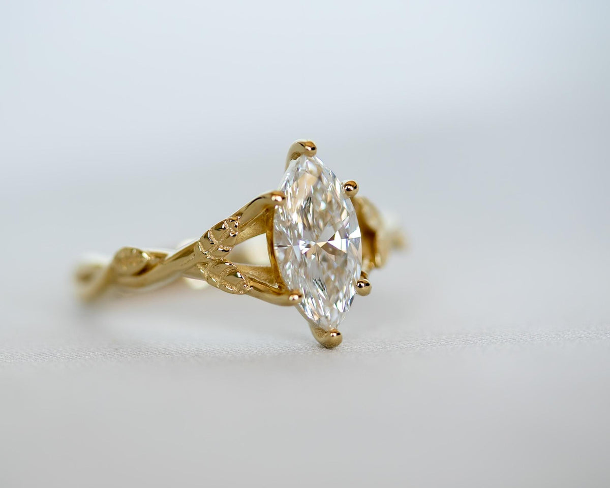Yellow gold marquise diamond ring with a leaf band, side view