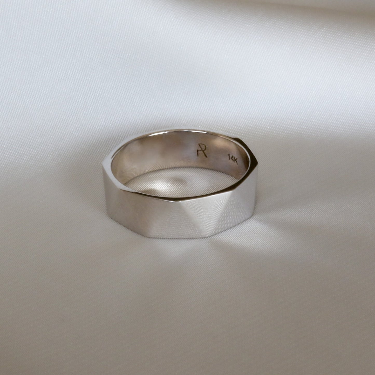 faceted triangle ring from top front view on white background