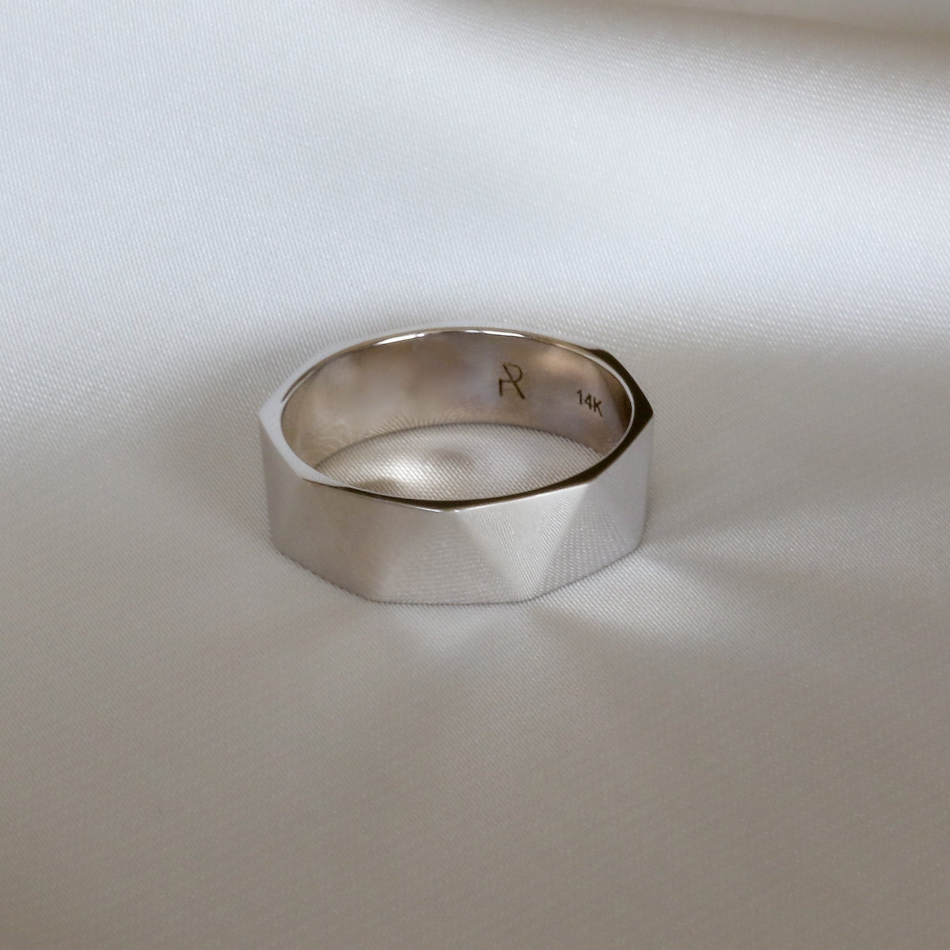 faceted triangle ring from top front view on white background