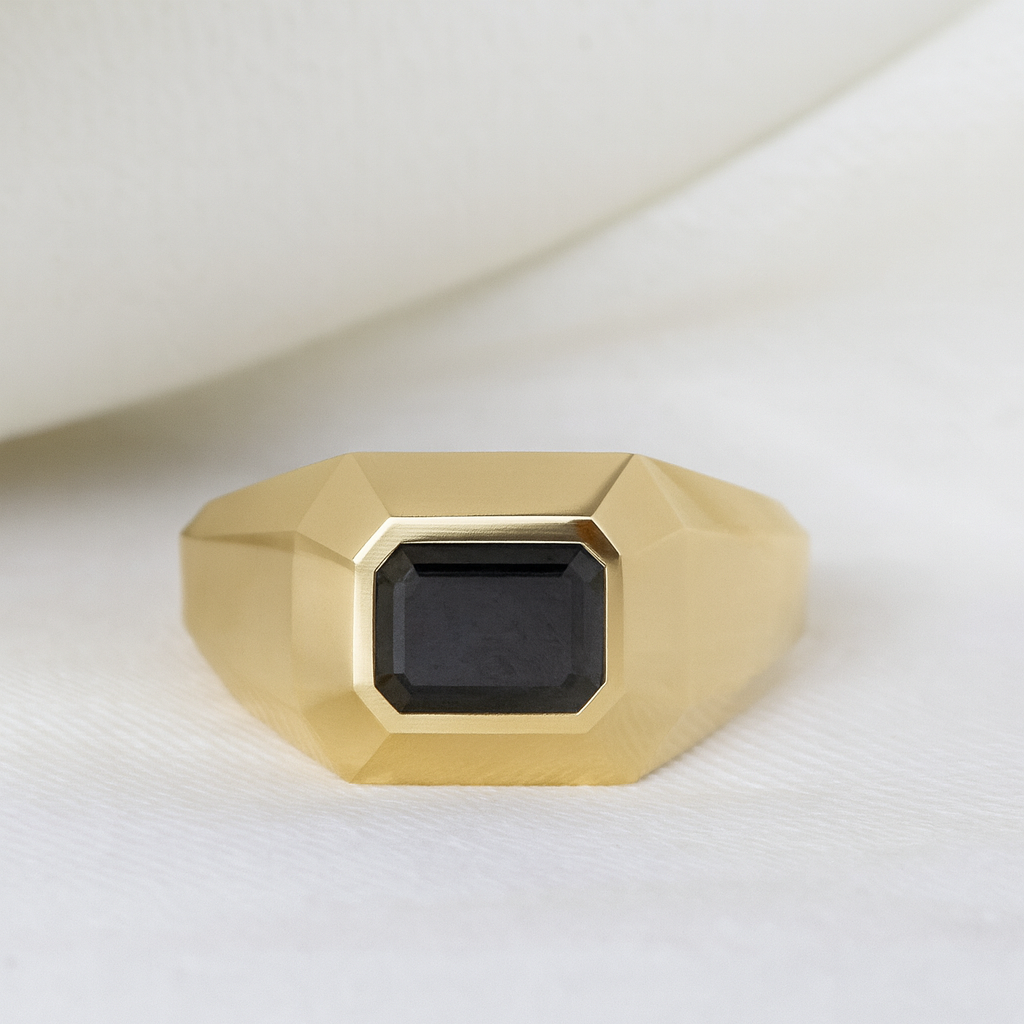 Men’s 14K yellow gold signet ring with emerald-cut black diamond on a white background — bold geometric design