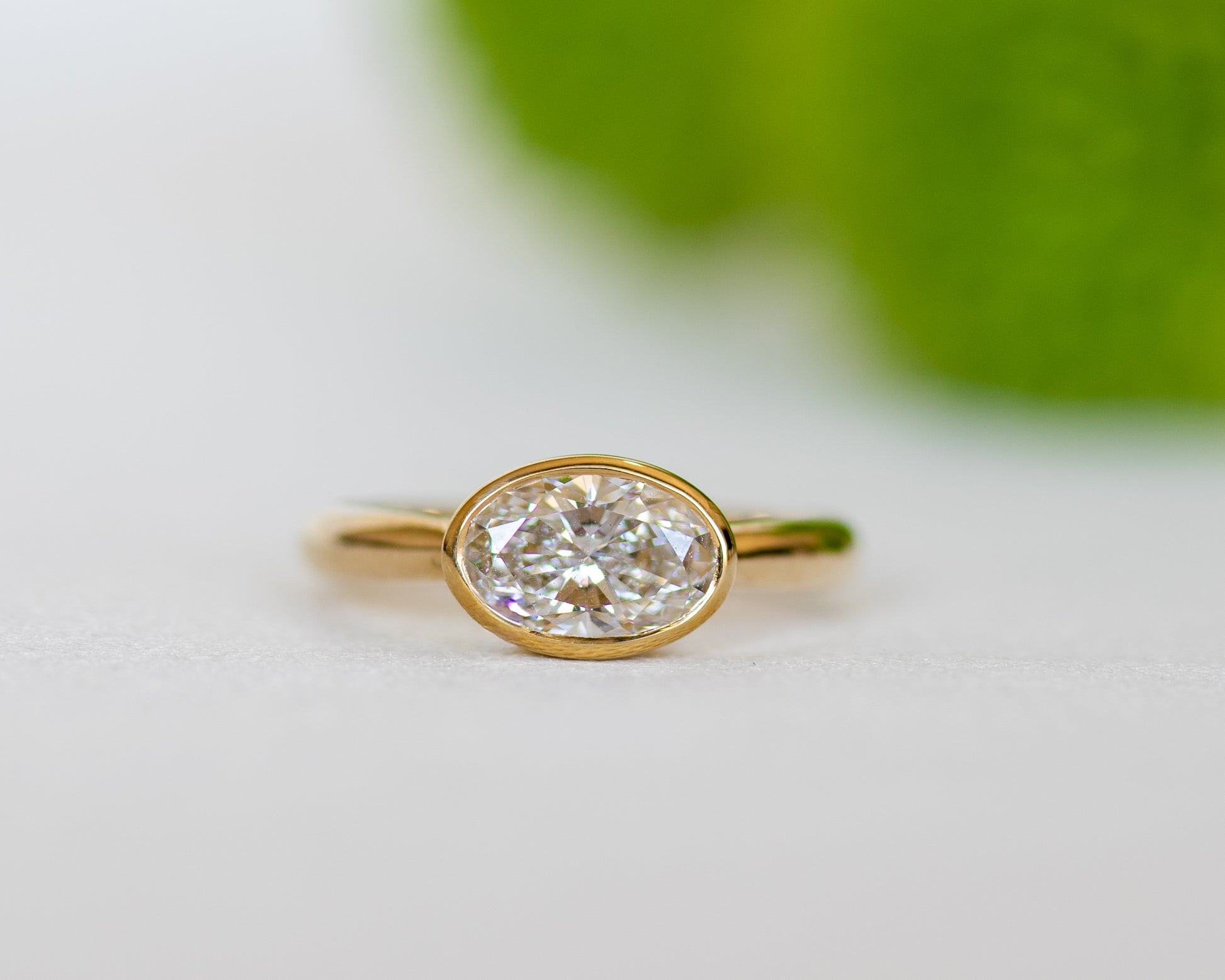 Delicate oval diamond ring in 14K yellow gold — minimalist bezel-set engagement ring by Rotem Avitan Jewelry.