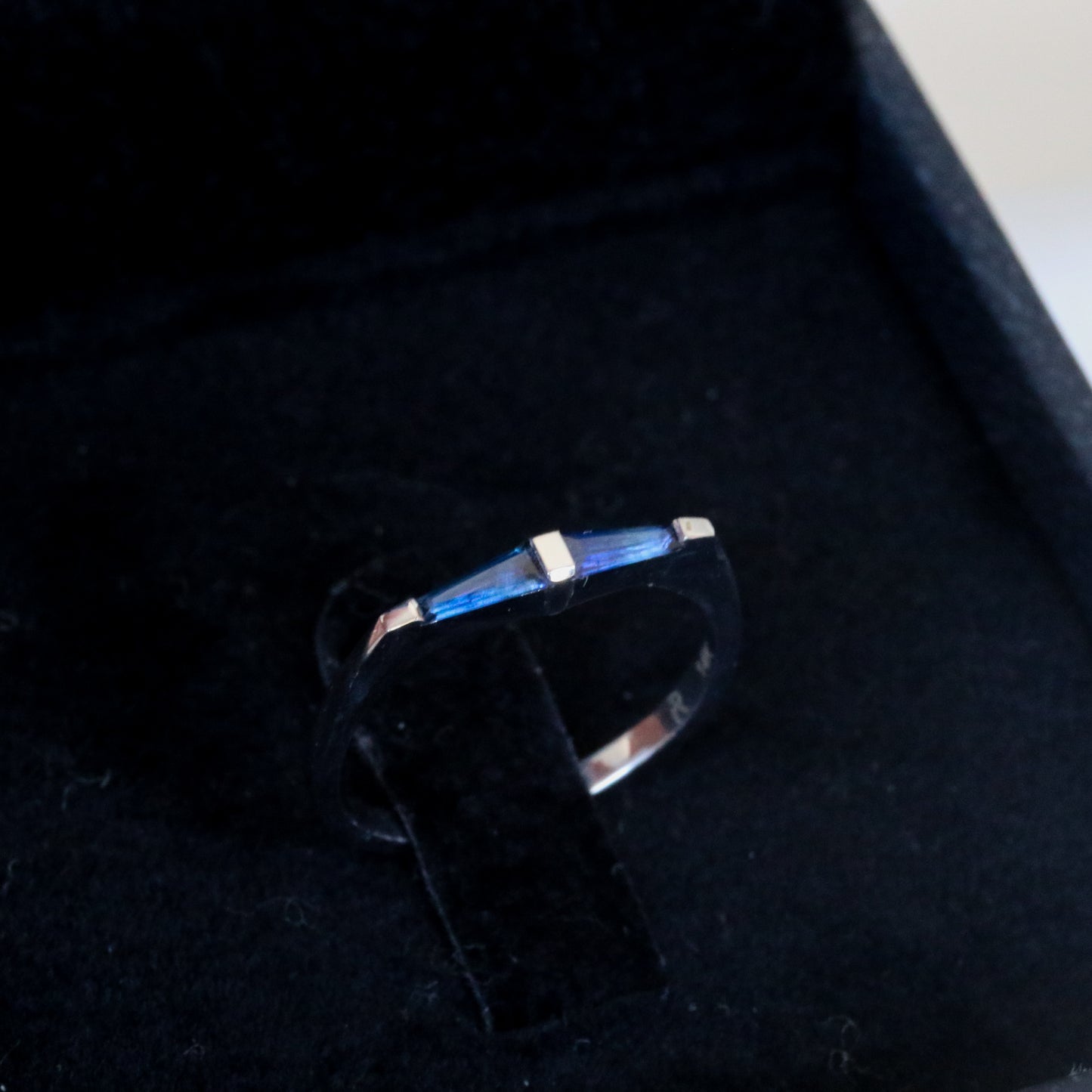 A 14K white gold ring with two natural blue tapered baguette cut sapphires in black velvet box