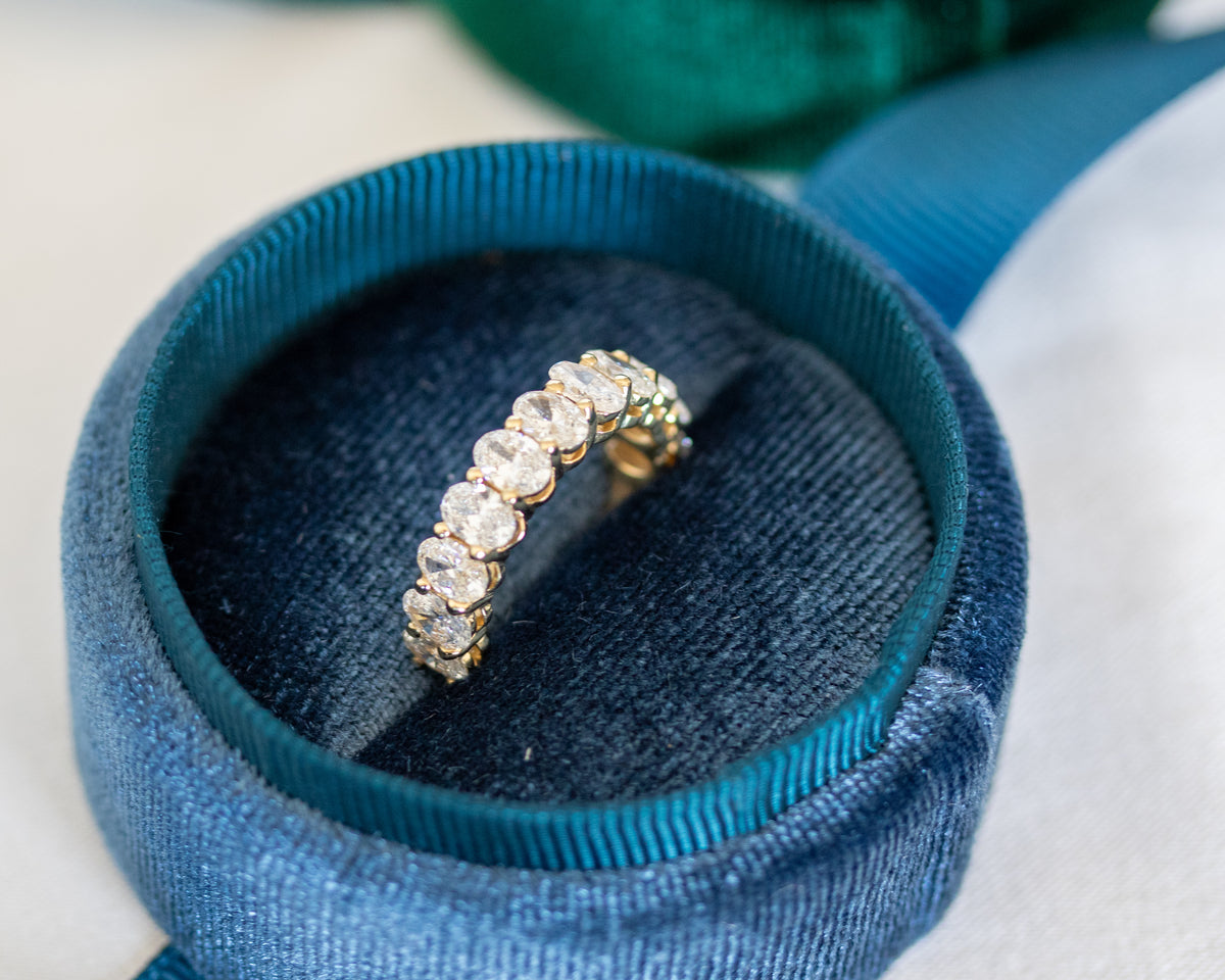 Close-up of oval diamonds set in a 14K gold half eternity band