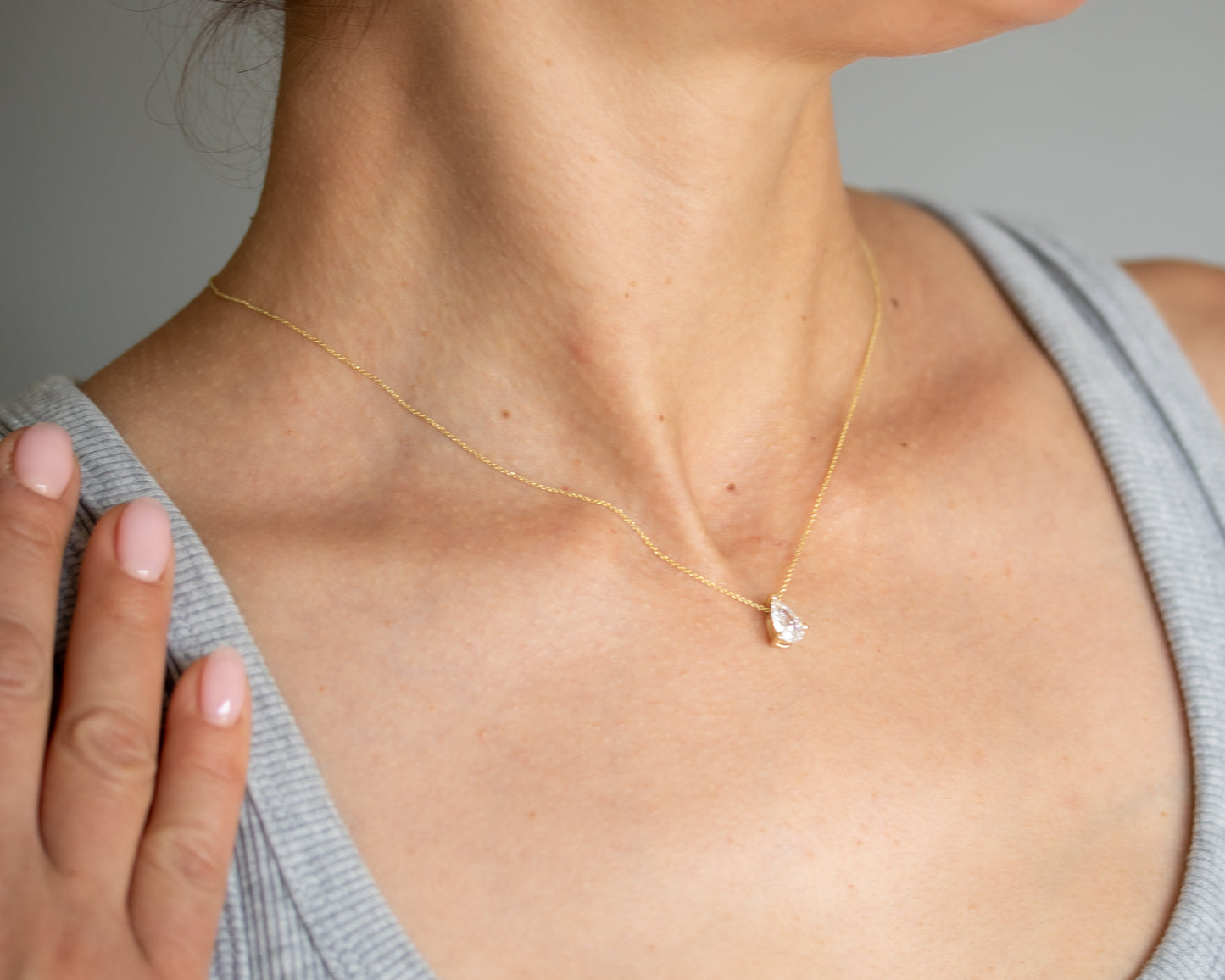 pear diamond solitaire necklace 14K gold worn close-up