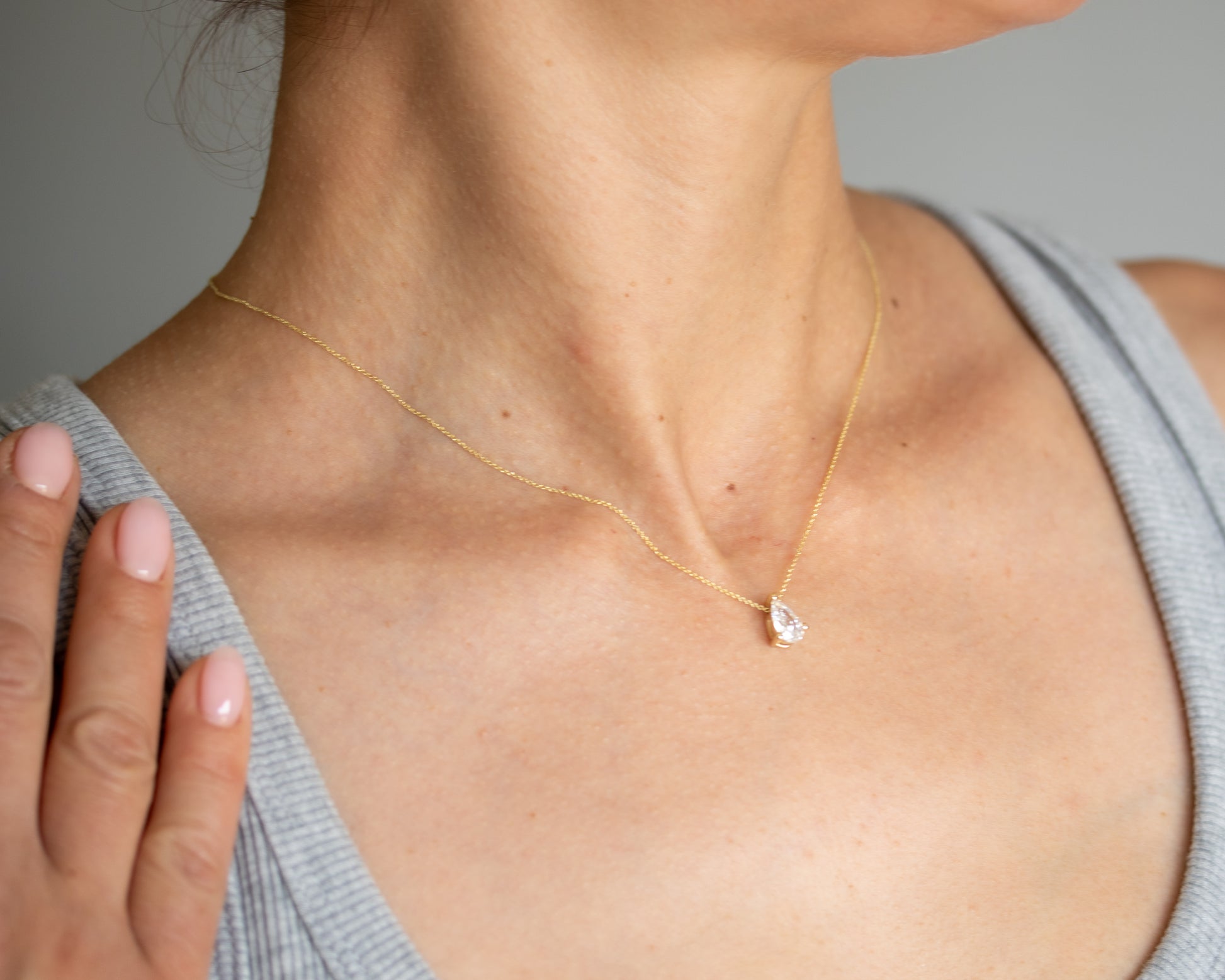 pear diamond solitaire necklace 14K gold worn close-up