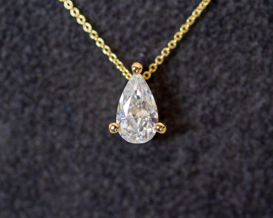 pear cut diamond solitaire pendant 14K yellow gold chain close-up