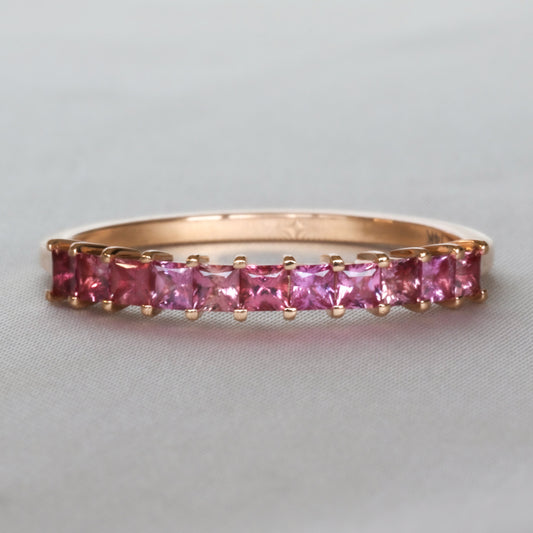 Natural pink sapphire half eternity band with princess cut stones in 14K rose gold, front view