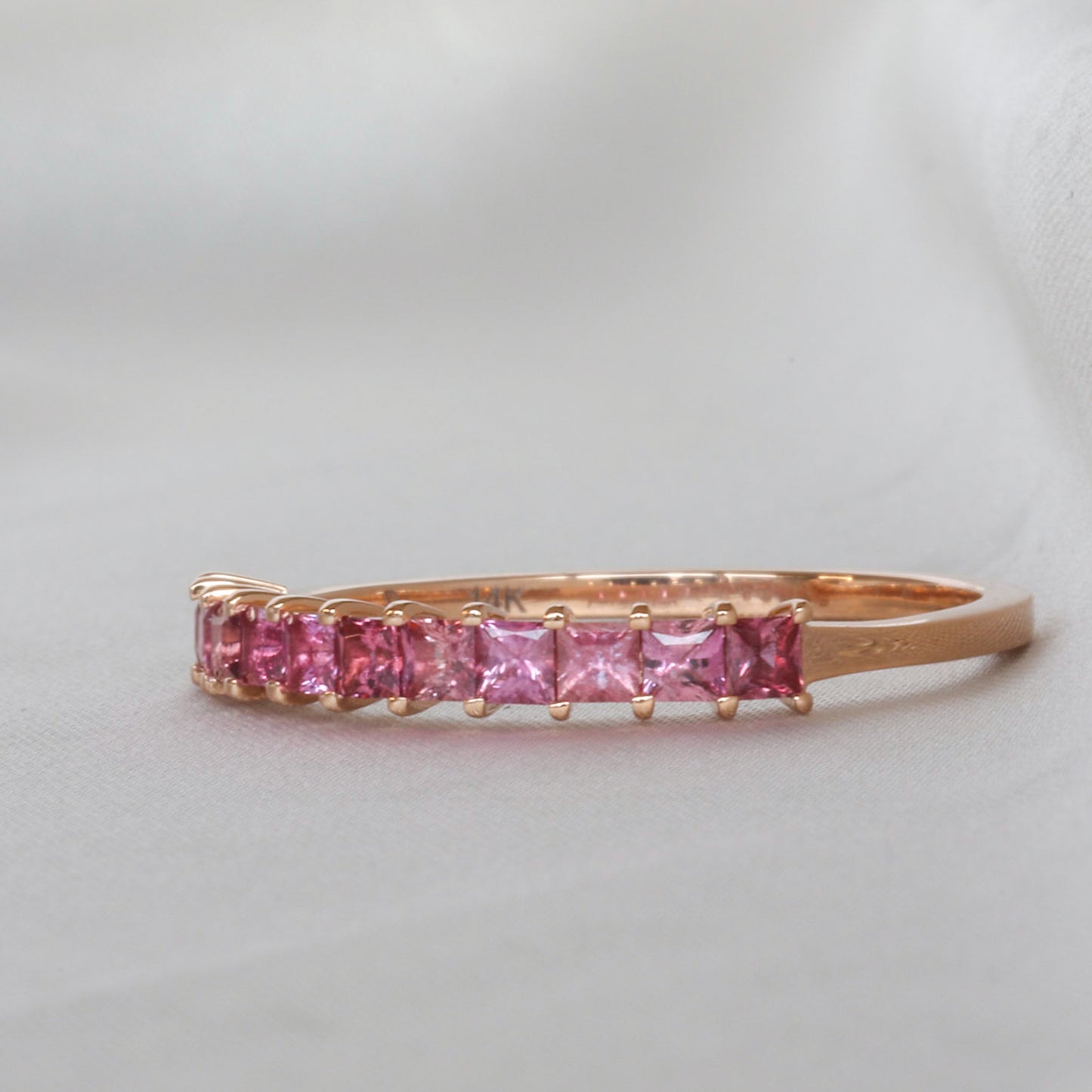 A princess cut natural sapphires eternity ring made from 14K gold, set with 11 natural sapphires.