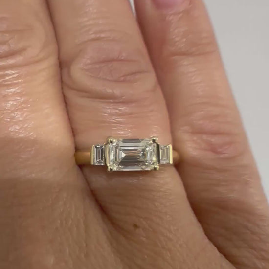 Emerald cut diamond trilogy ring worn on hand, video