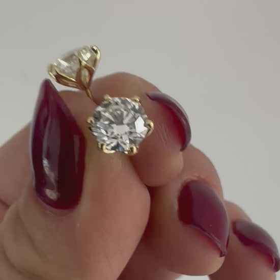 Diamond stud earrings in 14K gold, close-up in natural light