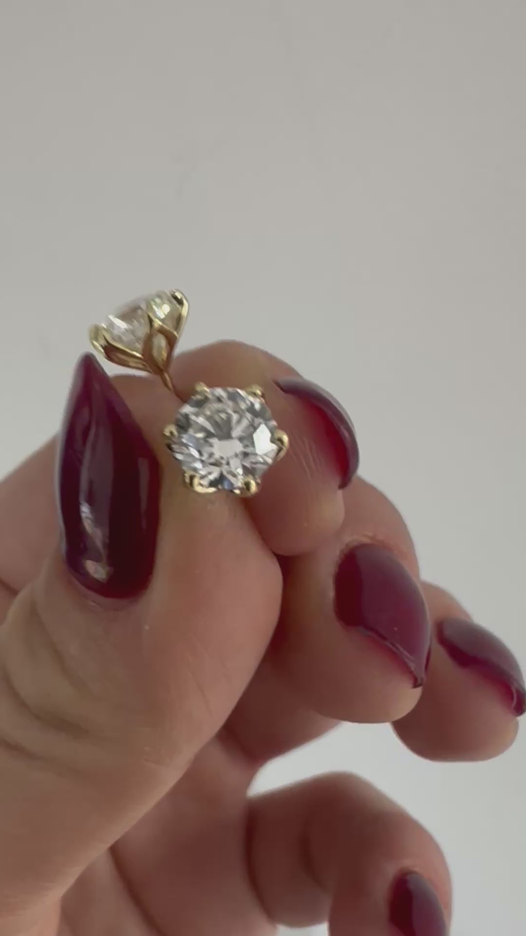 Diamond stud earrings in 14K gold, close-up in natural light