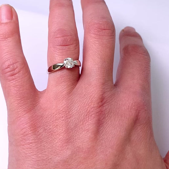video of classic solitaire four prong ring on womens hand