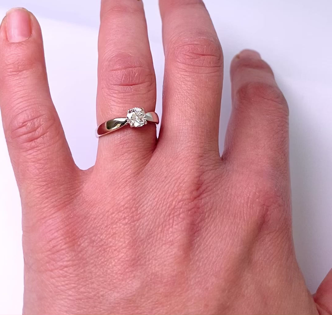 video of classic solitaire four prong ring on womens hand