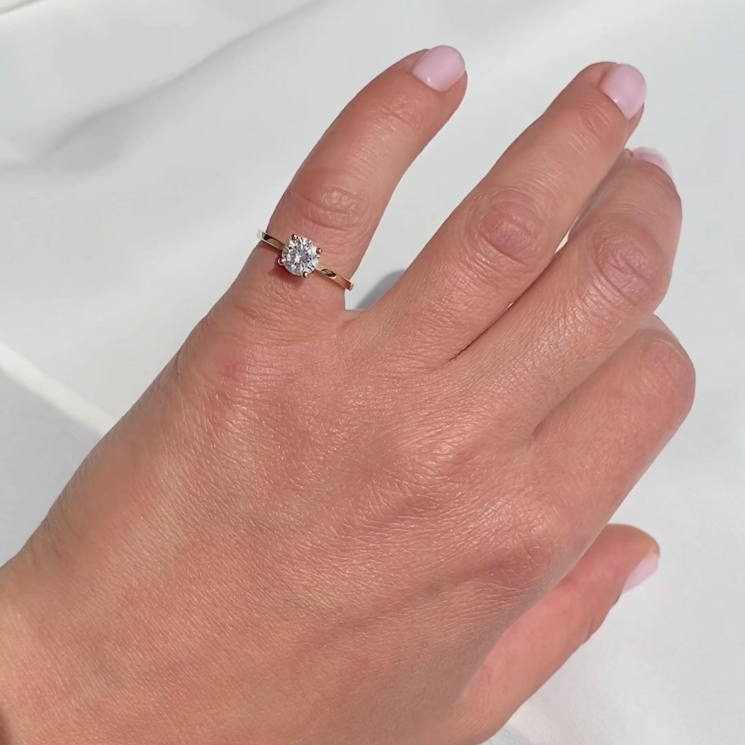 four prong minimalist diamond ring shown on hand