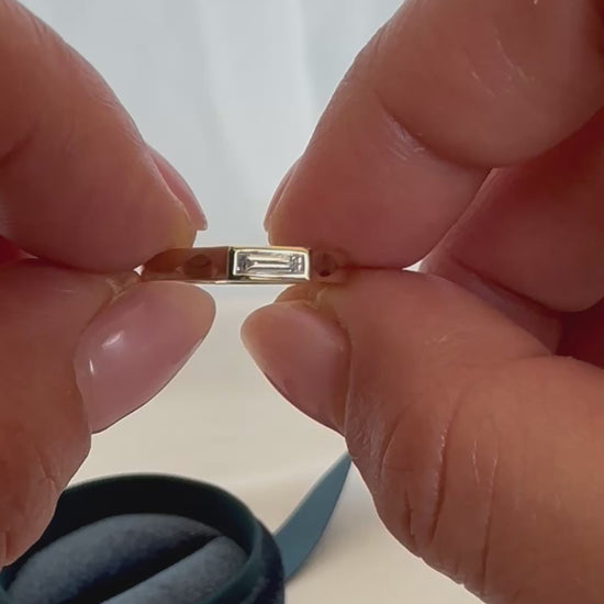 14K gold baguette diamond ring being worn on finger