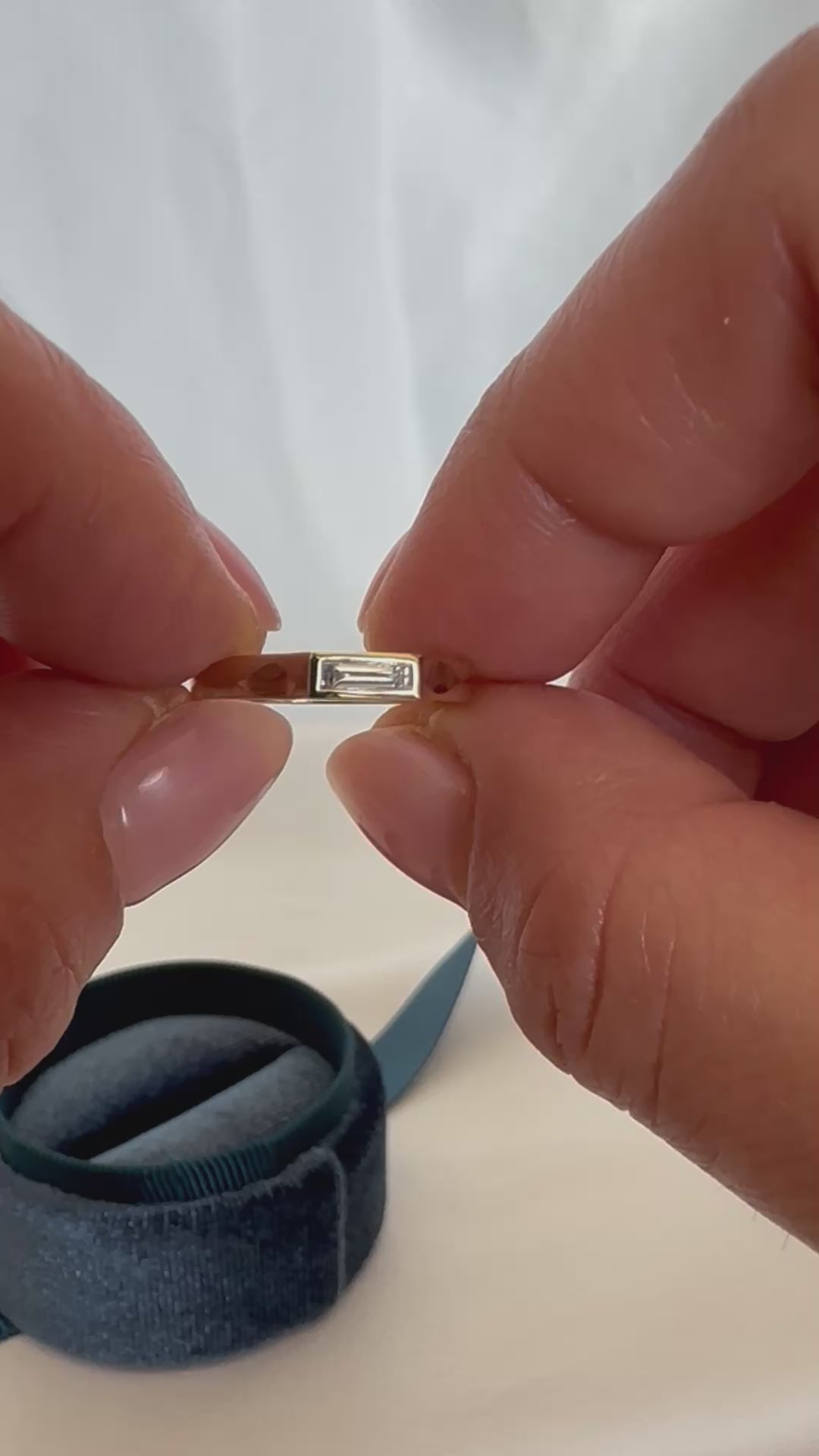 14K gold baguette diamond ring being worn on finger